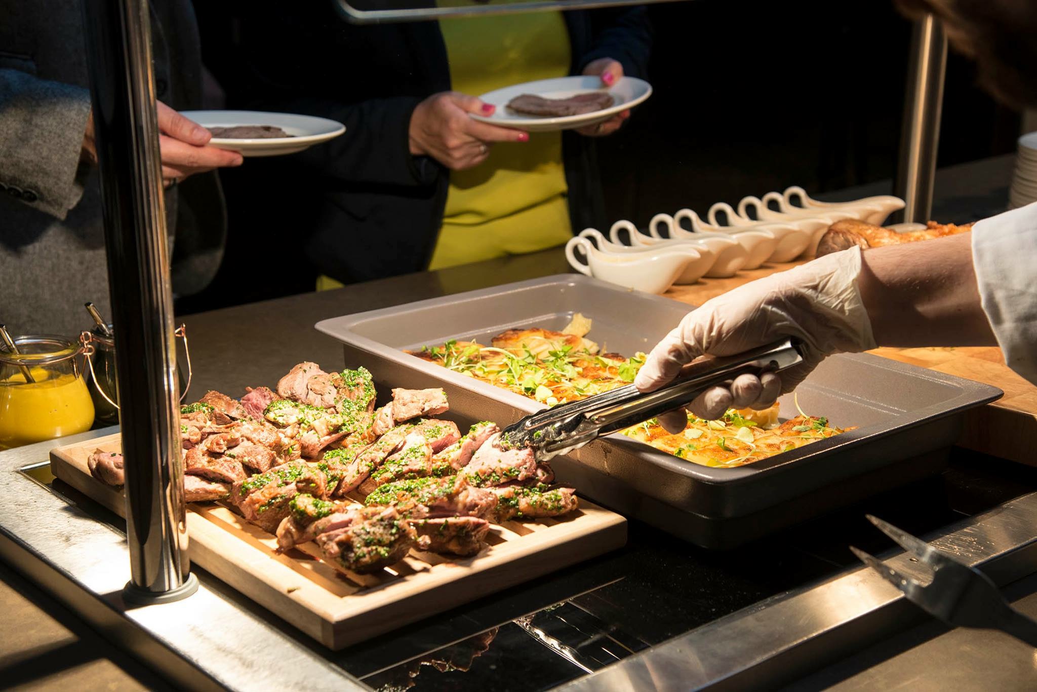 Claremont Suite buffet at DoubleTree London with grilled meat and vibrant sides for events.