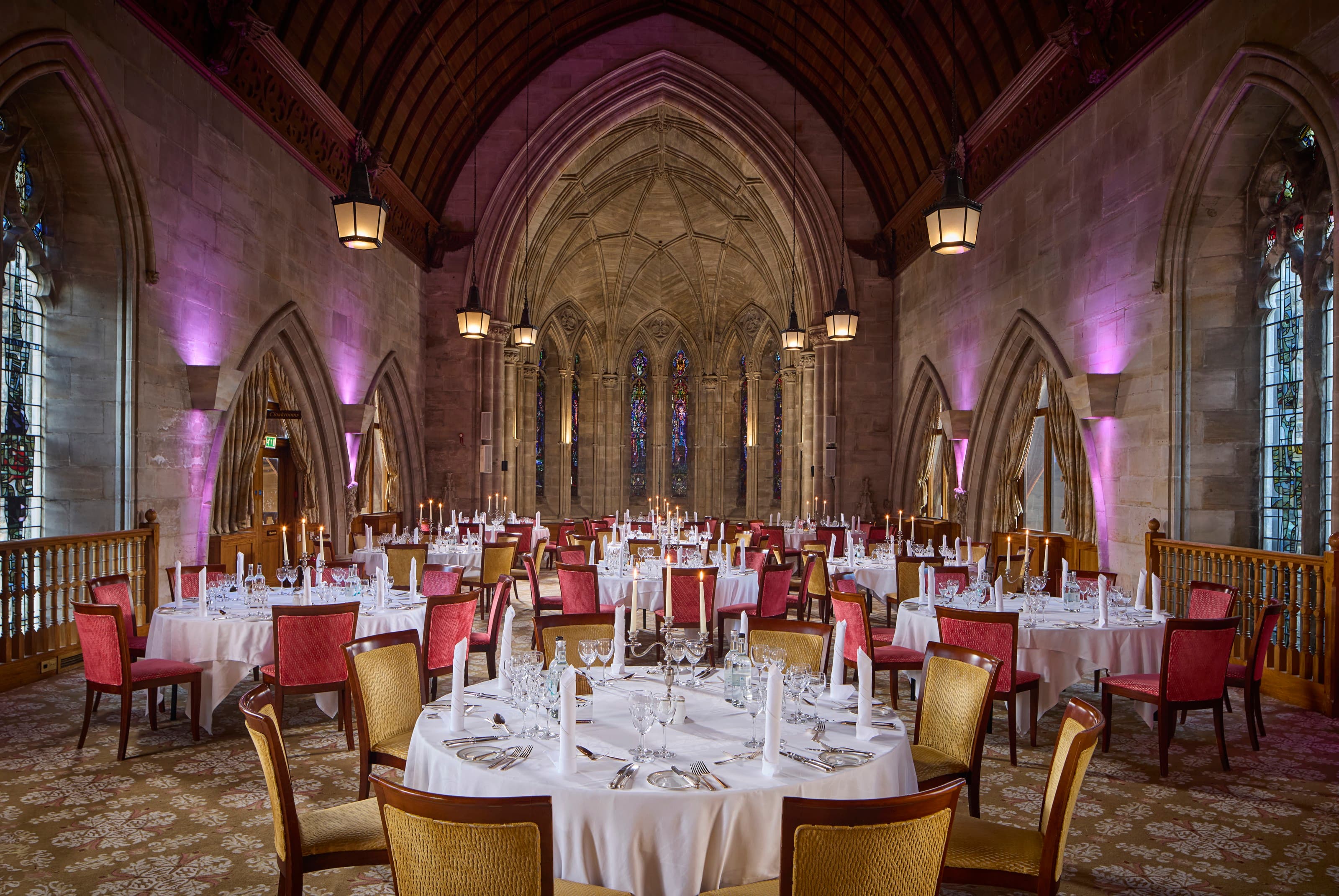 Harry Clarke gala dinner at Ashdown Park Hotel featuring dramatic architectural uplighting.