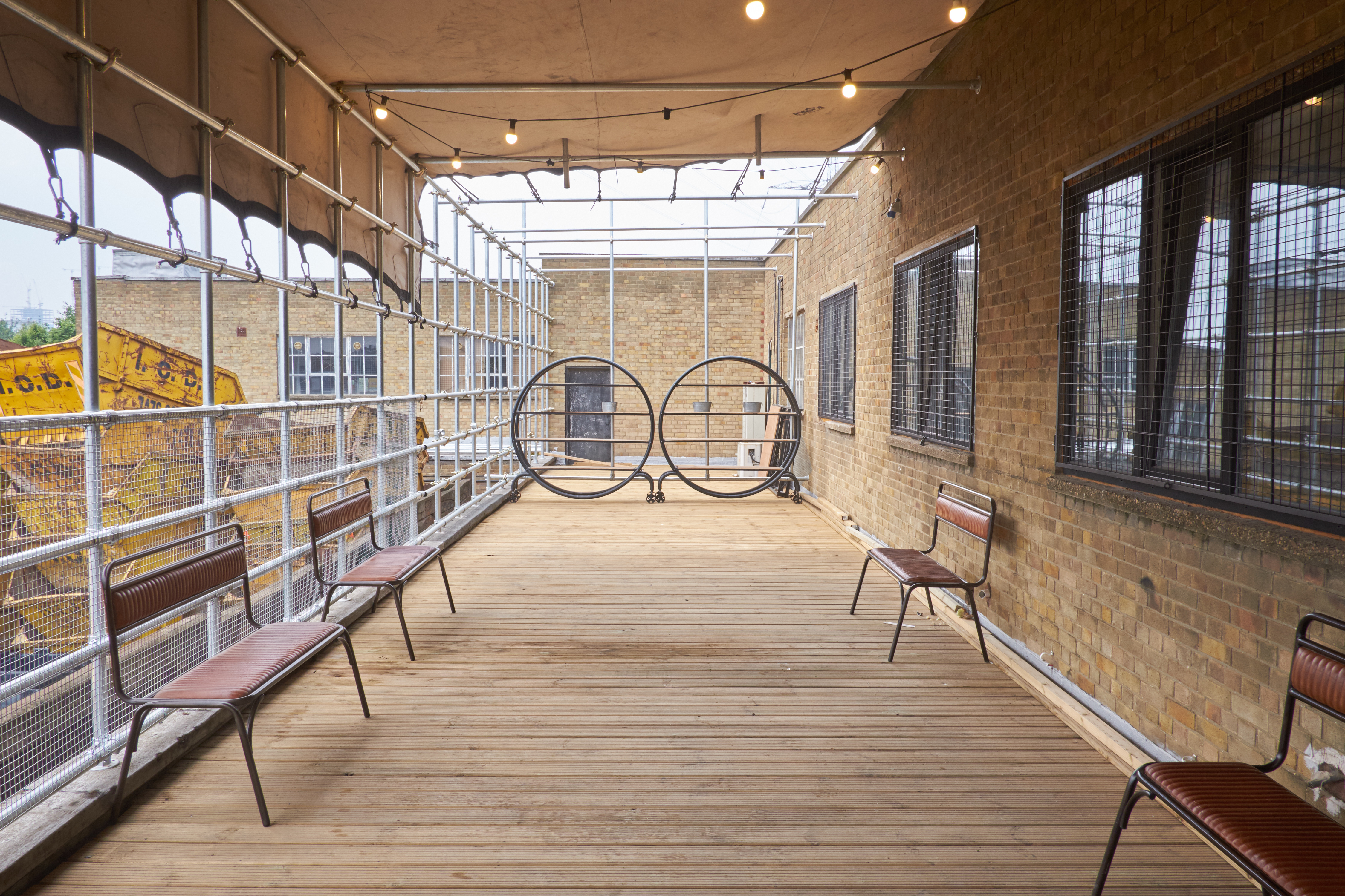 Versatile outdoor venue with wooden deck, ideal for networking events and casual meetings.