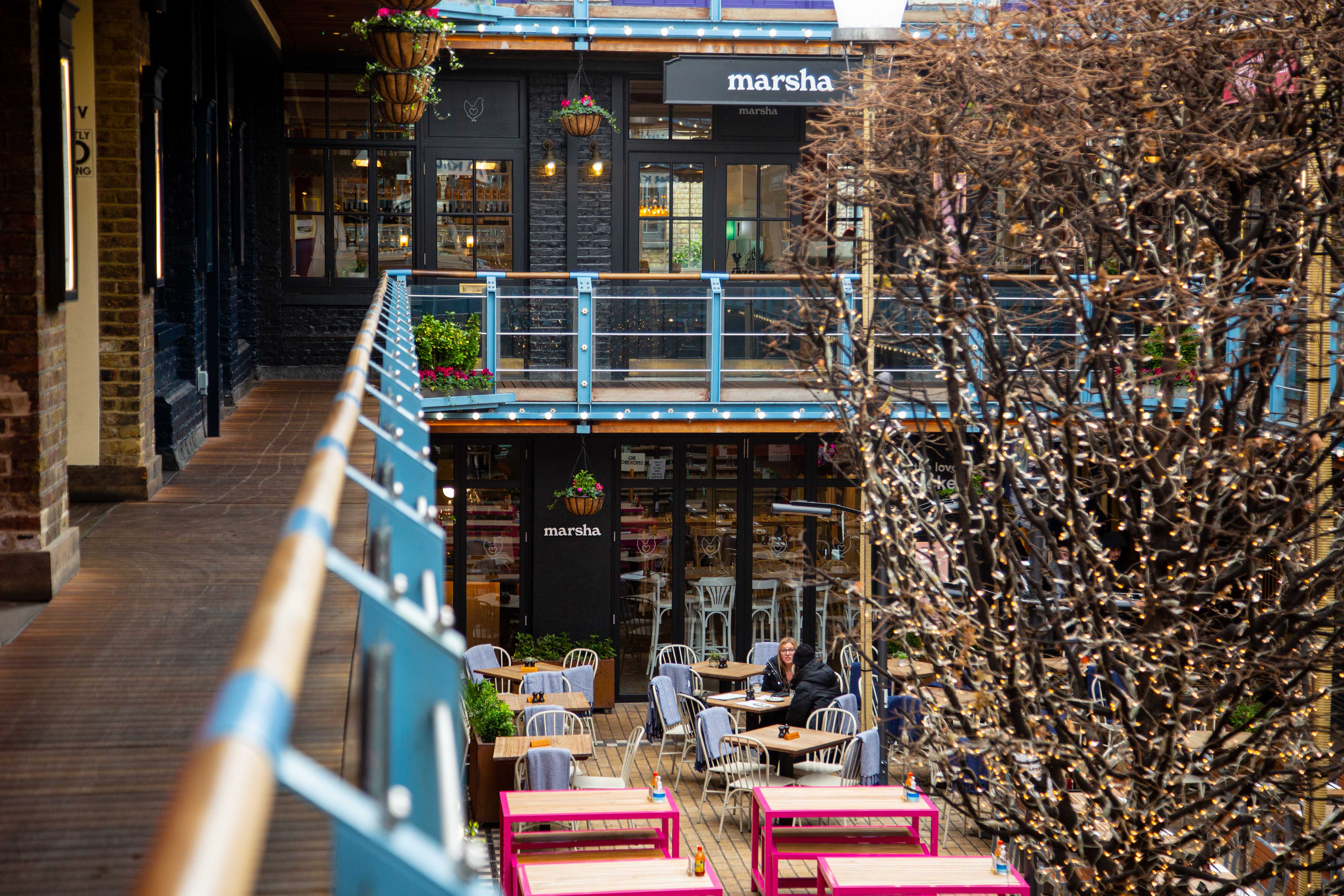 Vibrant outdoor event space with greenery and stylish seating at Paradiso Soho.
