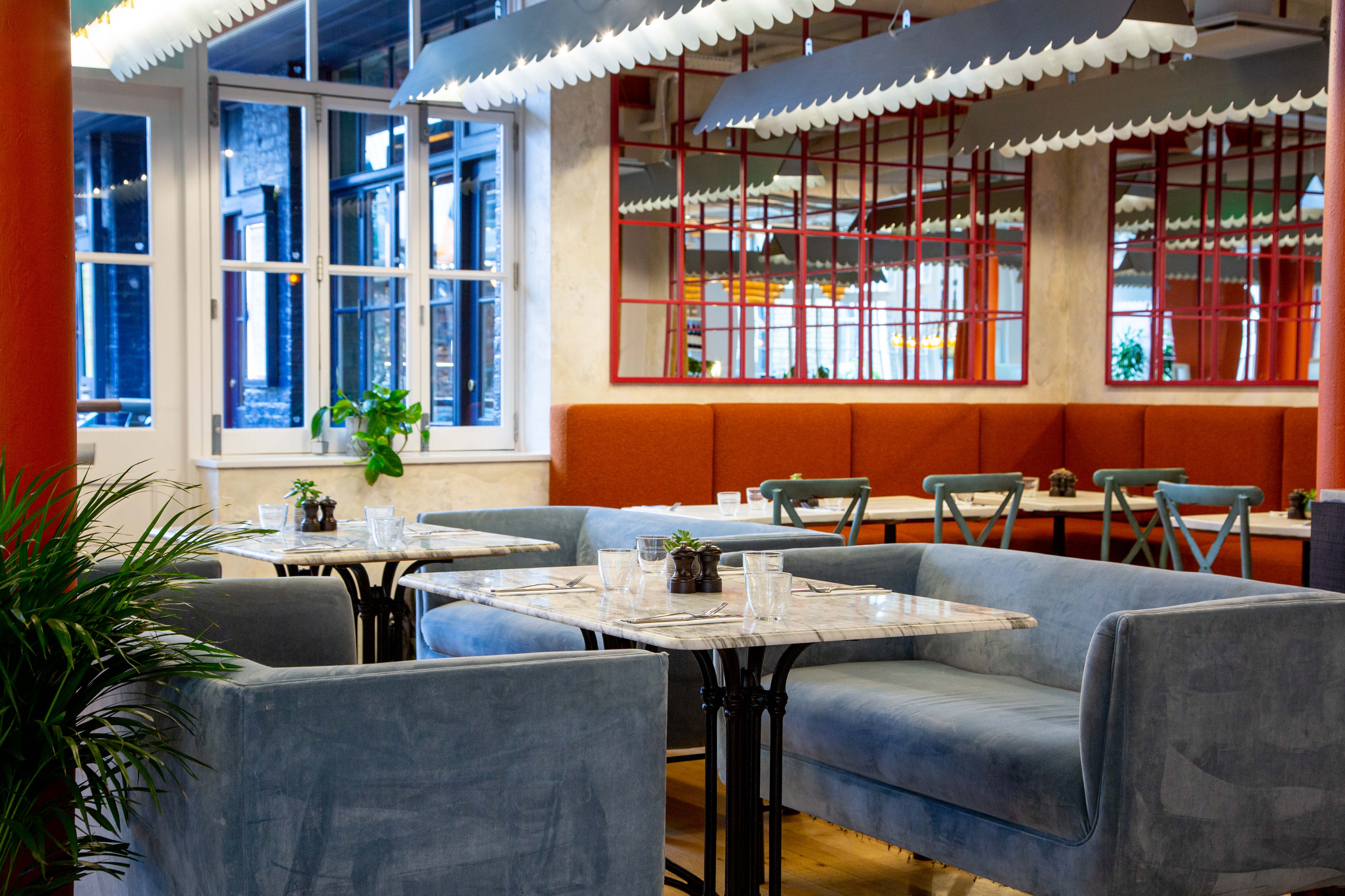 Modern event space with plush seating and natural light in Paradiso Soho.