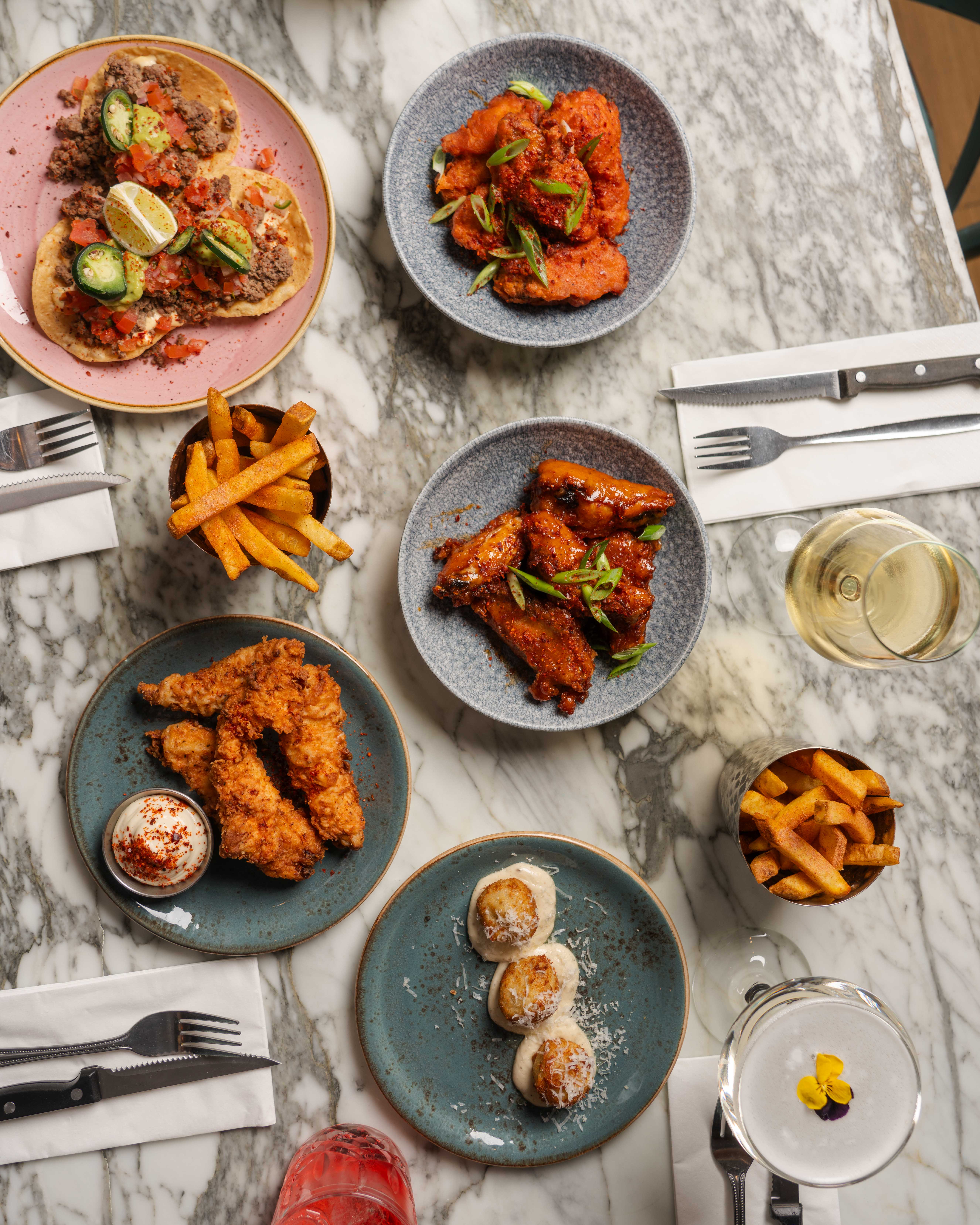 Vibrant food spread on marble tables for casual networking and team-building events.