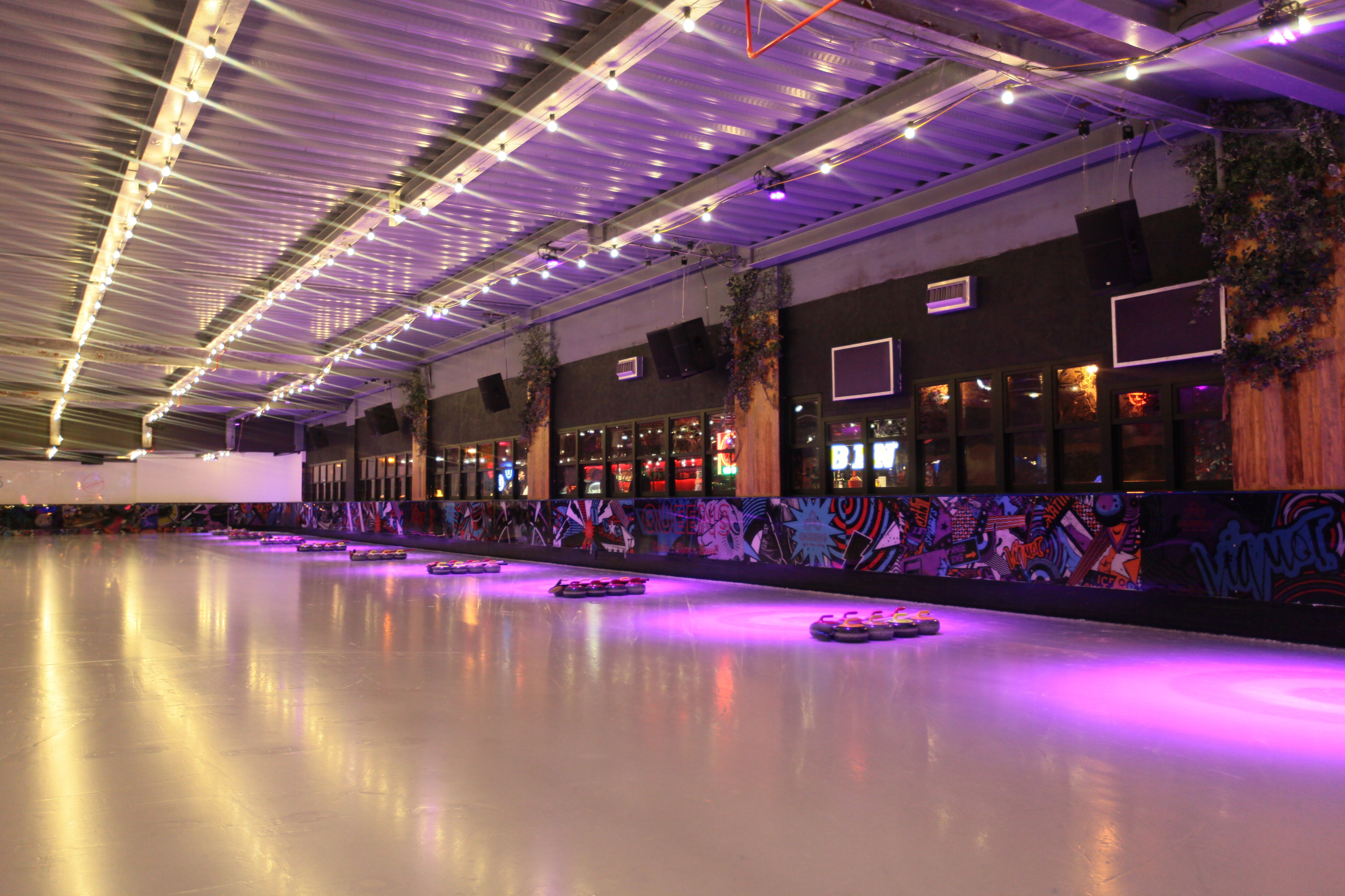 Vibrant indoor skating rink at QUEENS Skate Dine Bowl for events and gatherings.