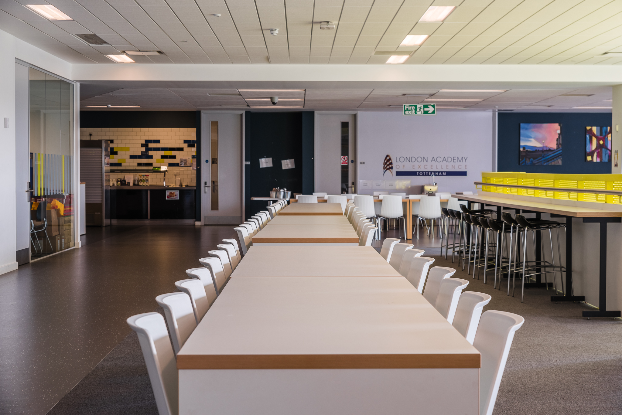 Modern dining space at London Academy of Excellence for workshops and gatherings.