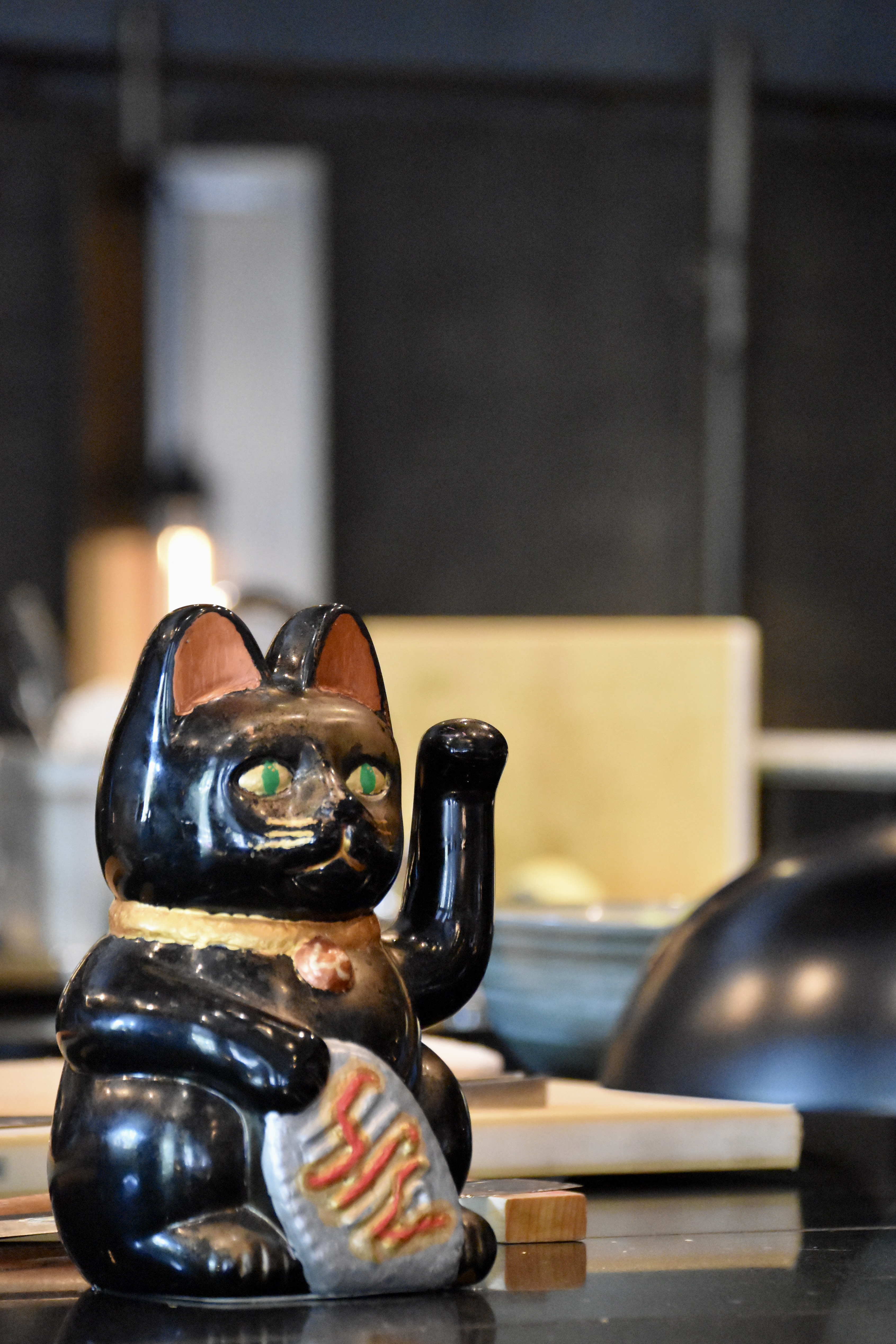 Black cat figurine at Exclusive Hire, Lucky Cat by Gordon Ramsay for unique event decor.