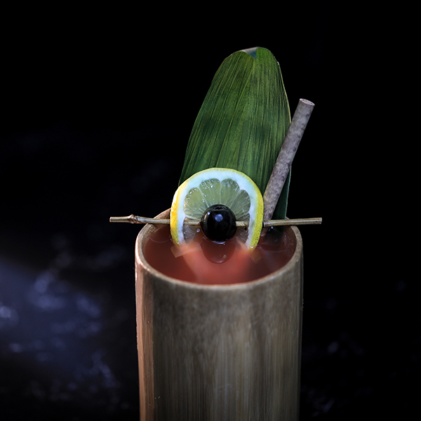 Cocktail presentation in bamboo at upscale event by Gordon Ramsay, perfect for parties.