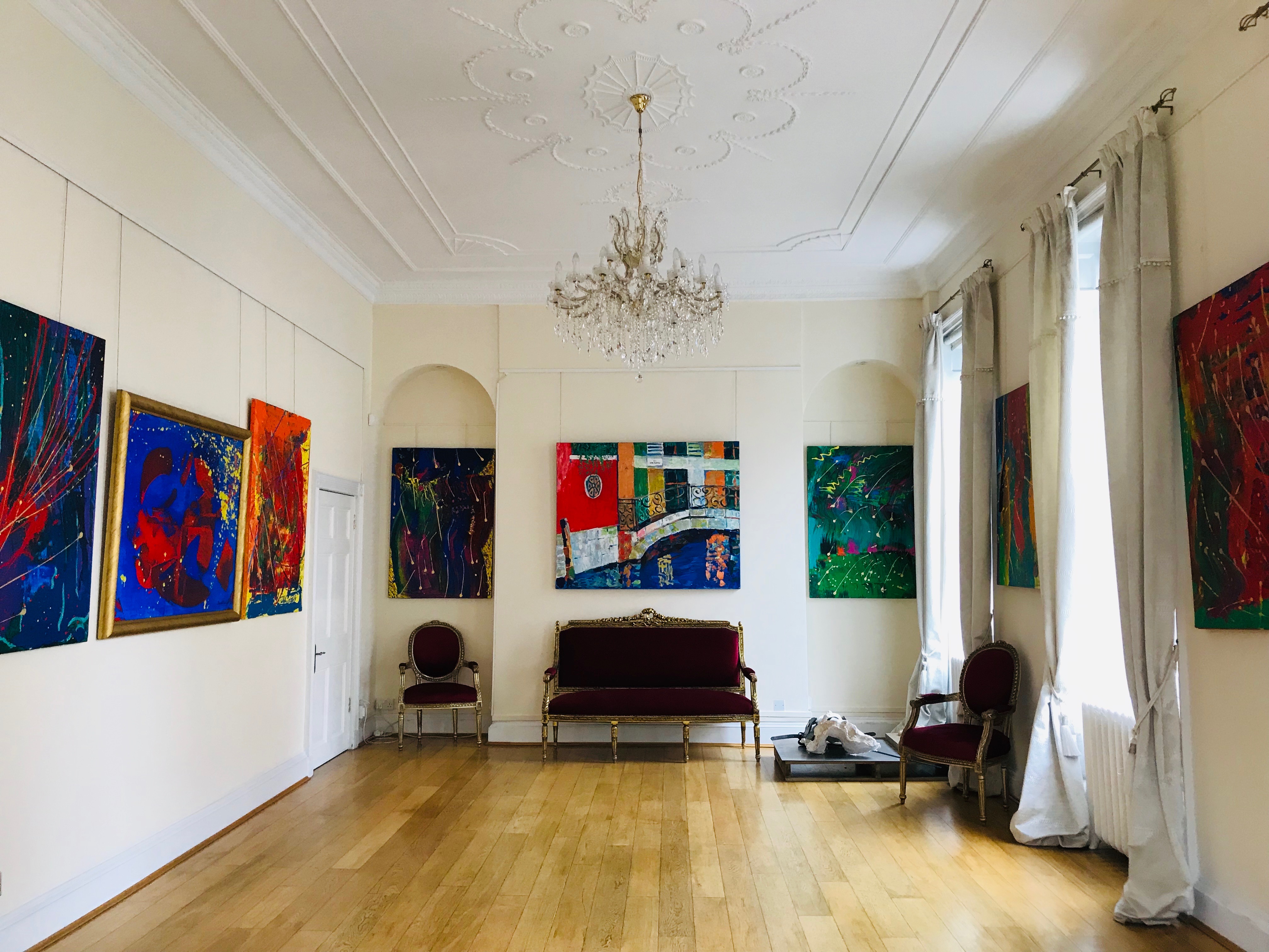 Elegant Grand Hall with vibrant artwork, perfect for meetings and gatherings.