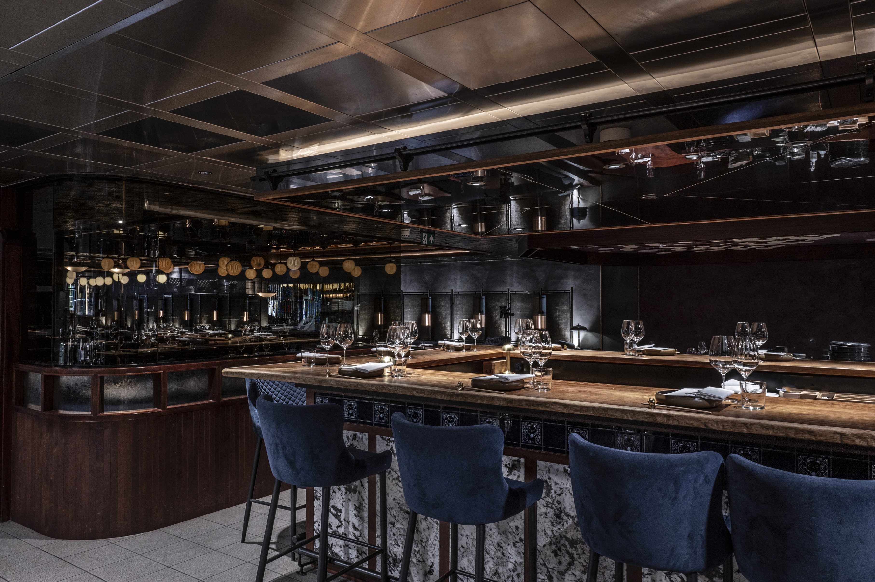 Sophisticated kitchen table at Lucky Cat by Gordon Ramsay for intimate gatherings and events.