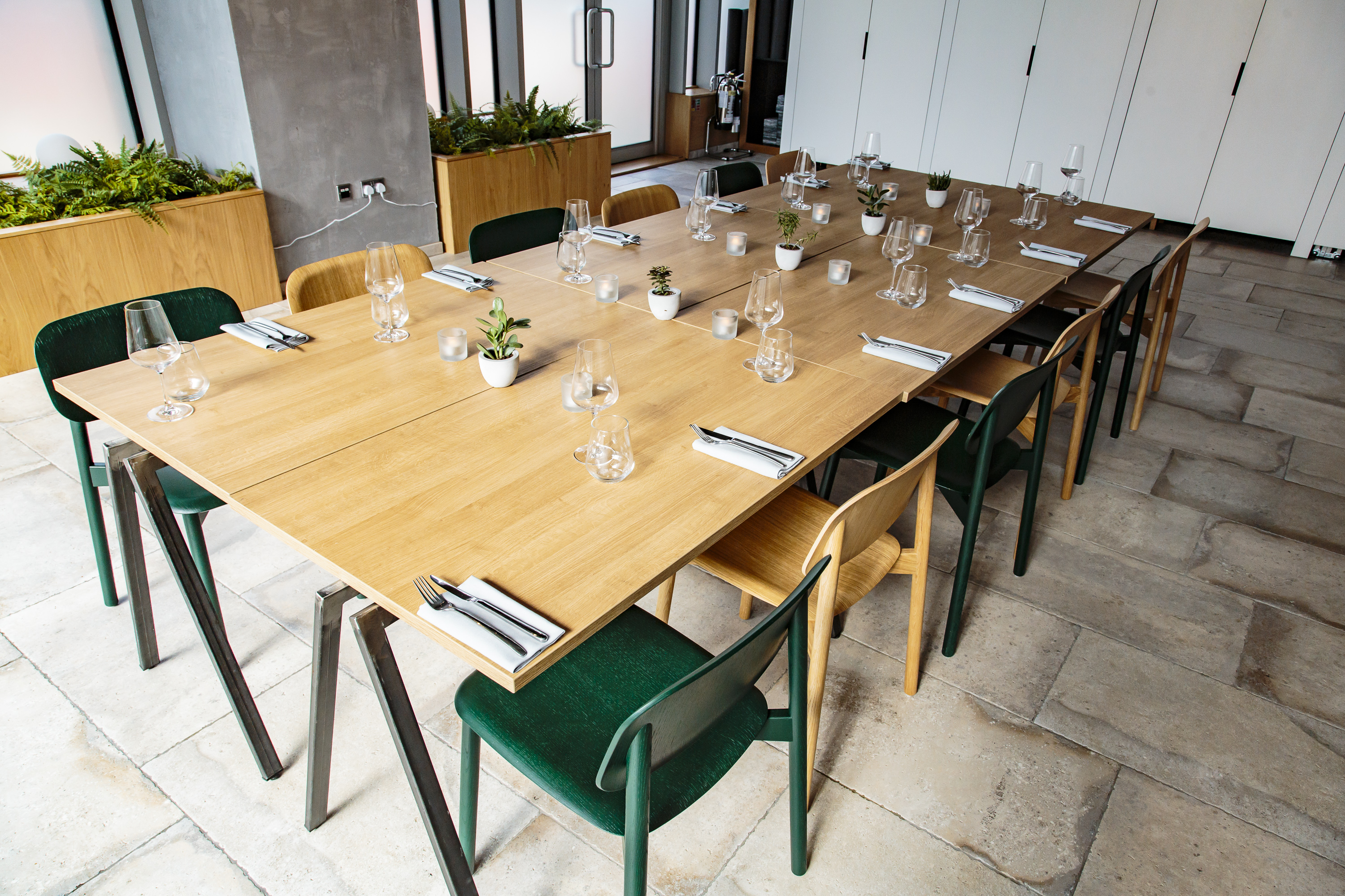 "Elegant meeting space with wooden table, ideal for networking events and discussions."