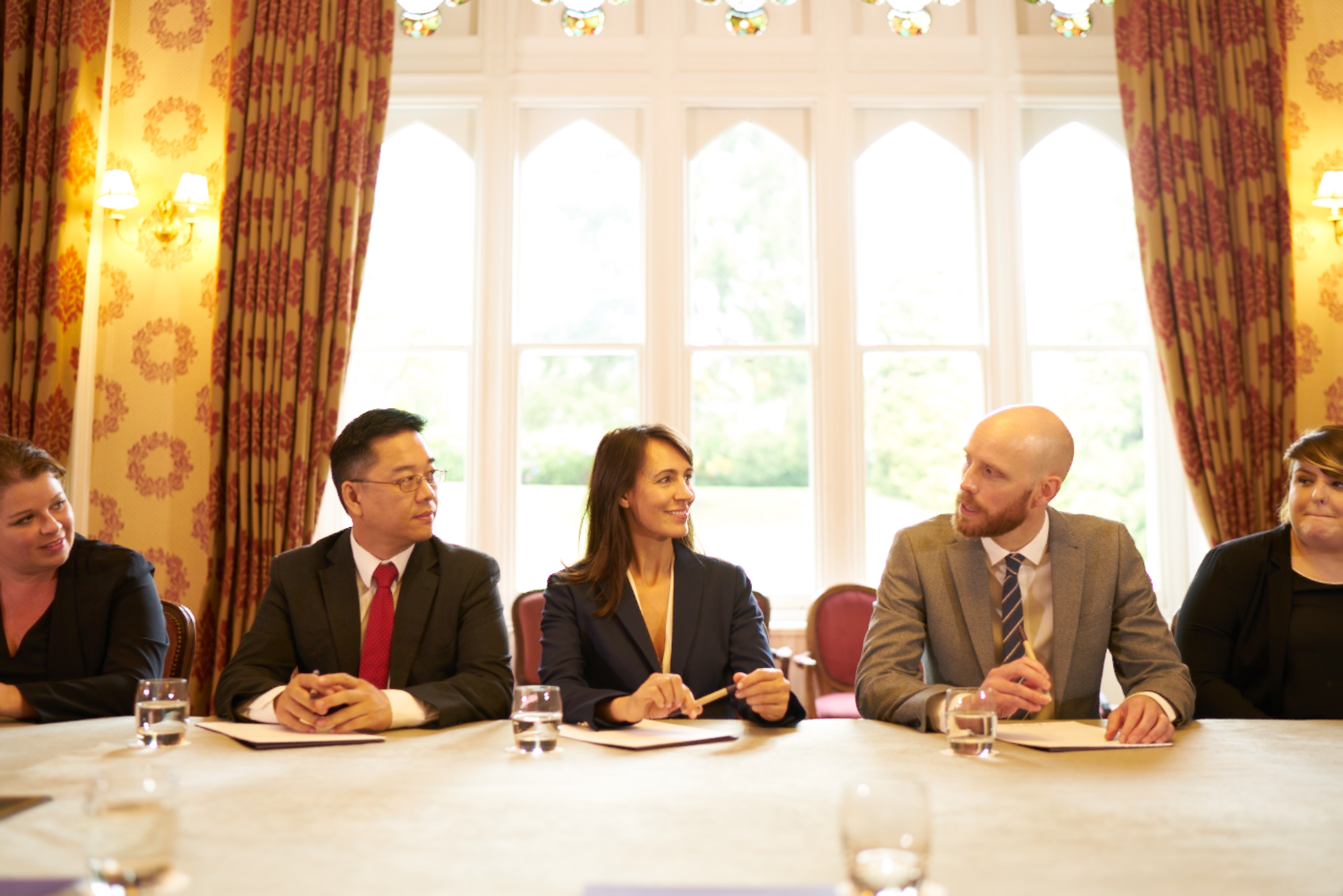 Jacob Henniker leads a professional meeting in Ashdown Park Hotel, fostering collaboration.