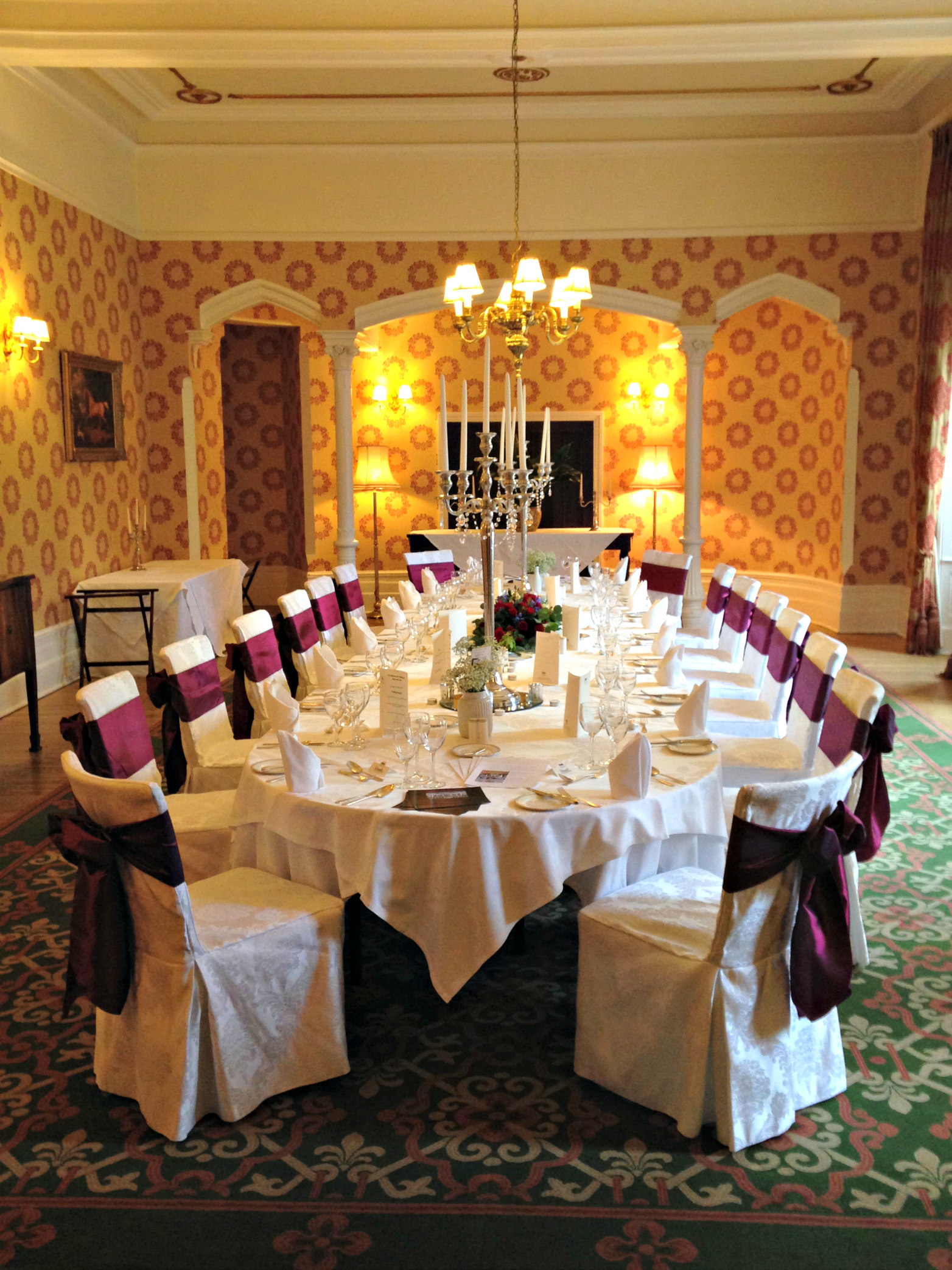 Elegant dining room with candelabra at Ashdown Park for formal events and galas.