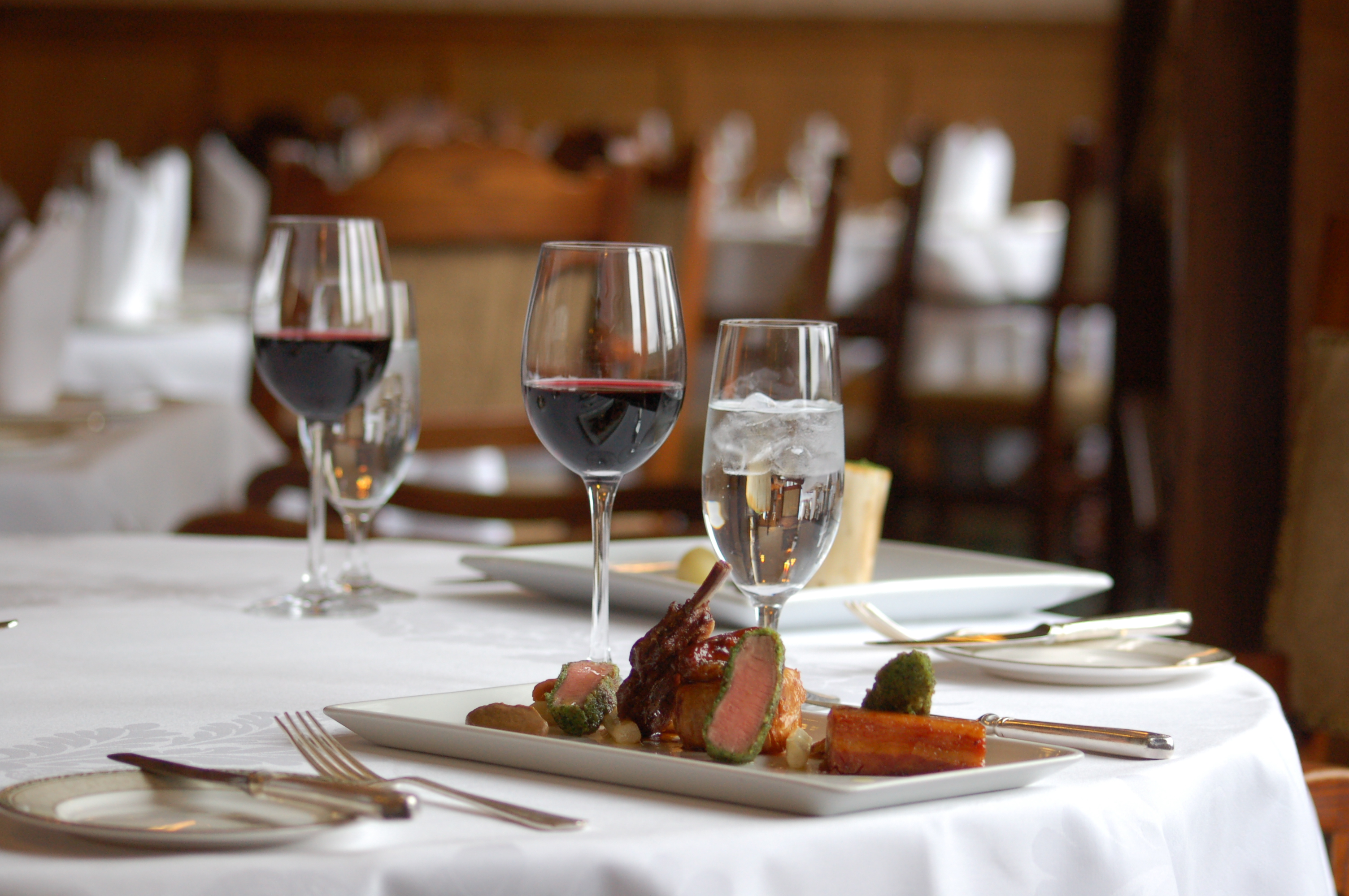 Jacob Henniker at an elegant dining table for a corporate gala in Ashdown Park Hotel.