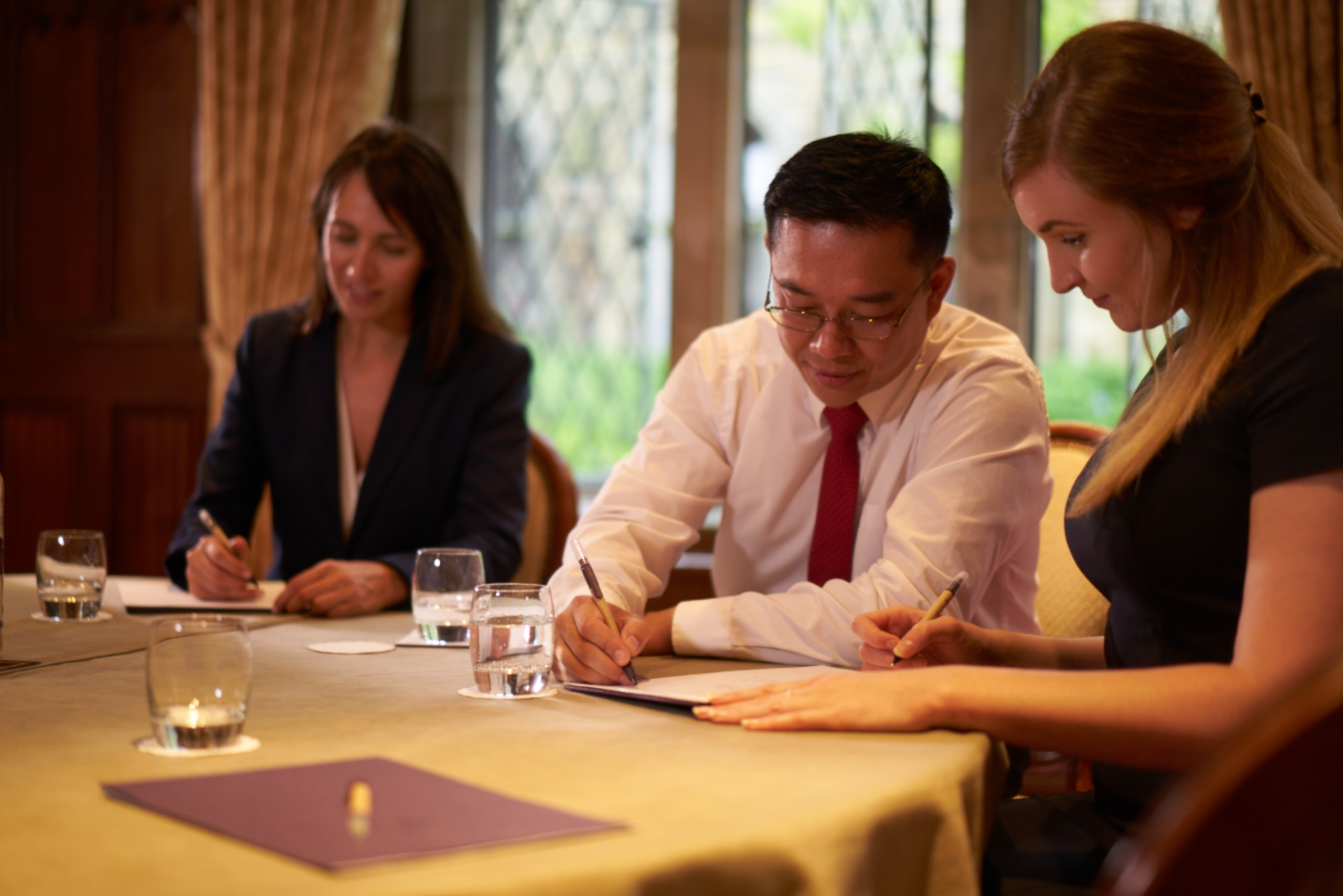 Lady Brassey at Ashdown Park Hotel, focused meeting with professionals in elegant decor.