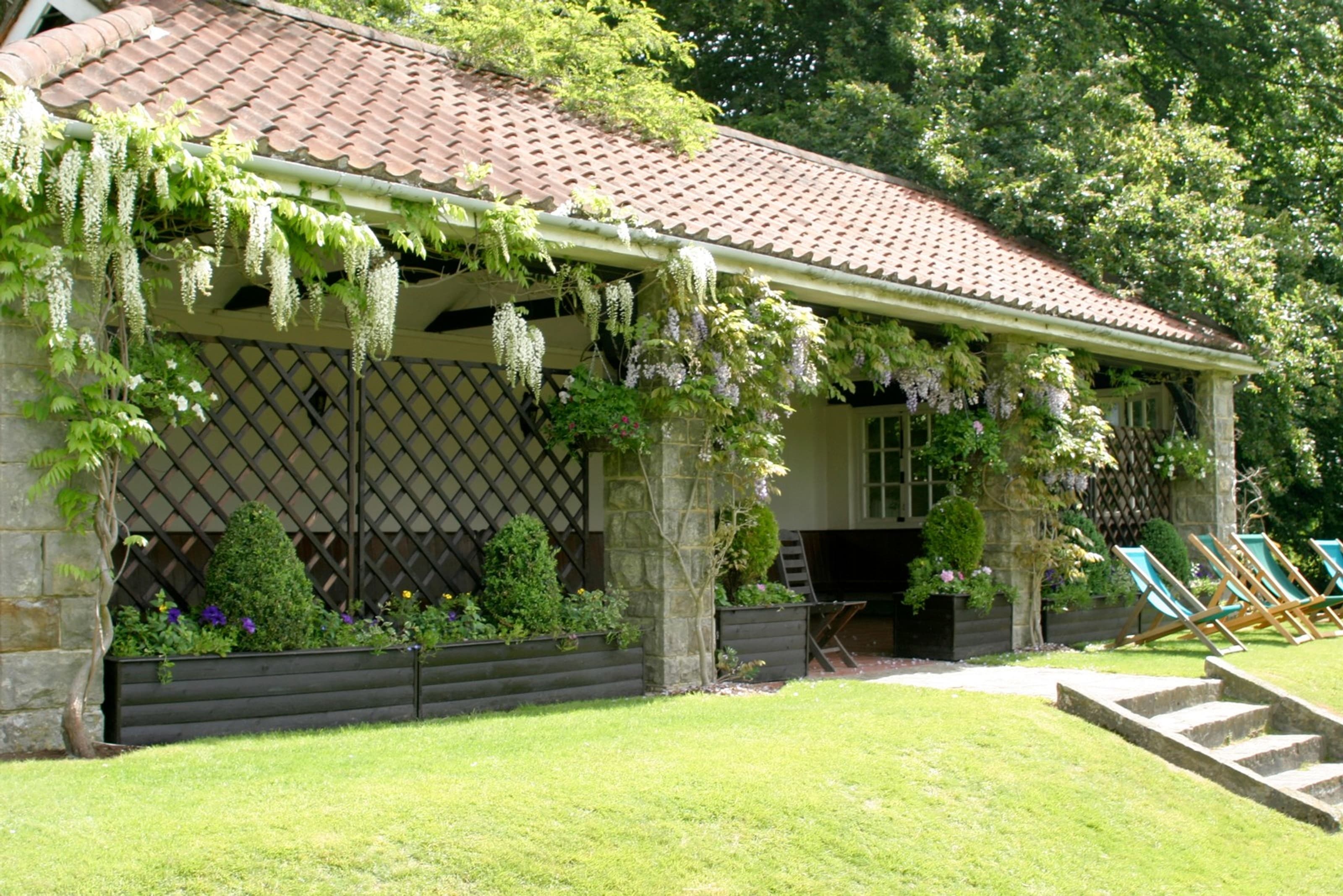 Summerhouse outdoor networking space at Ashdown Park Hotel for rustic garden events.