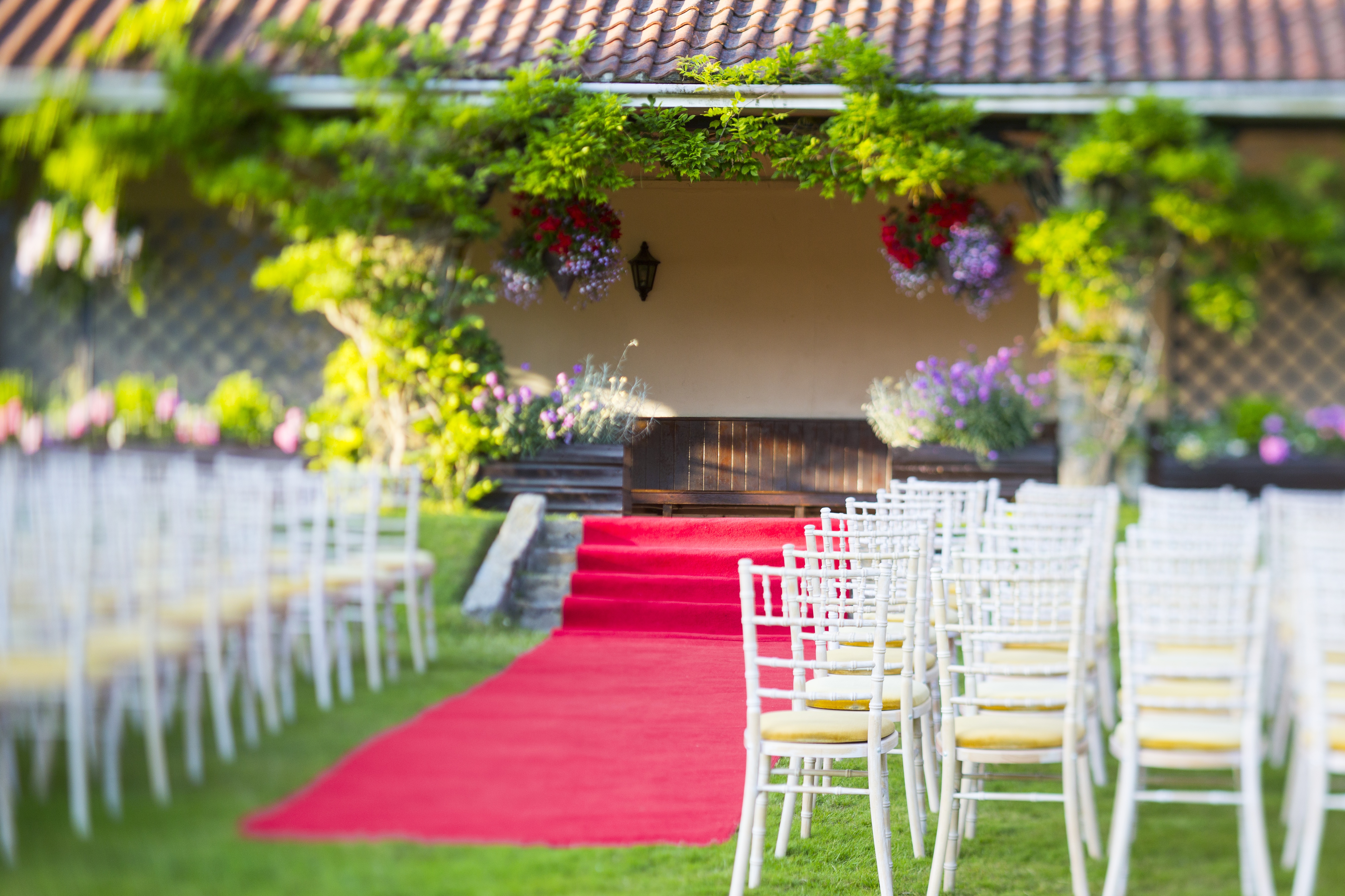 Summerhouse at Ashdown Park: elegant outdoor wedding venue with red carpet and lush greenery.
