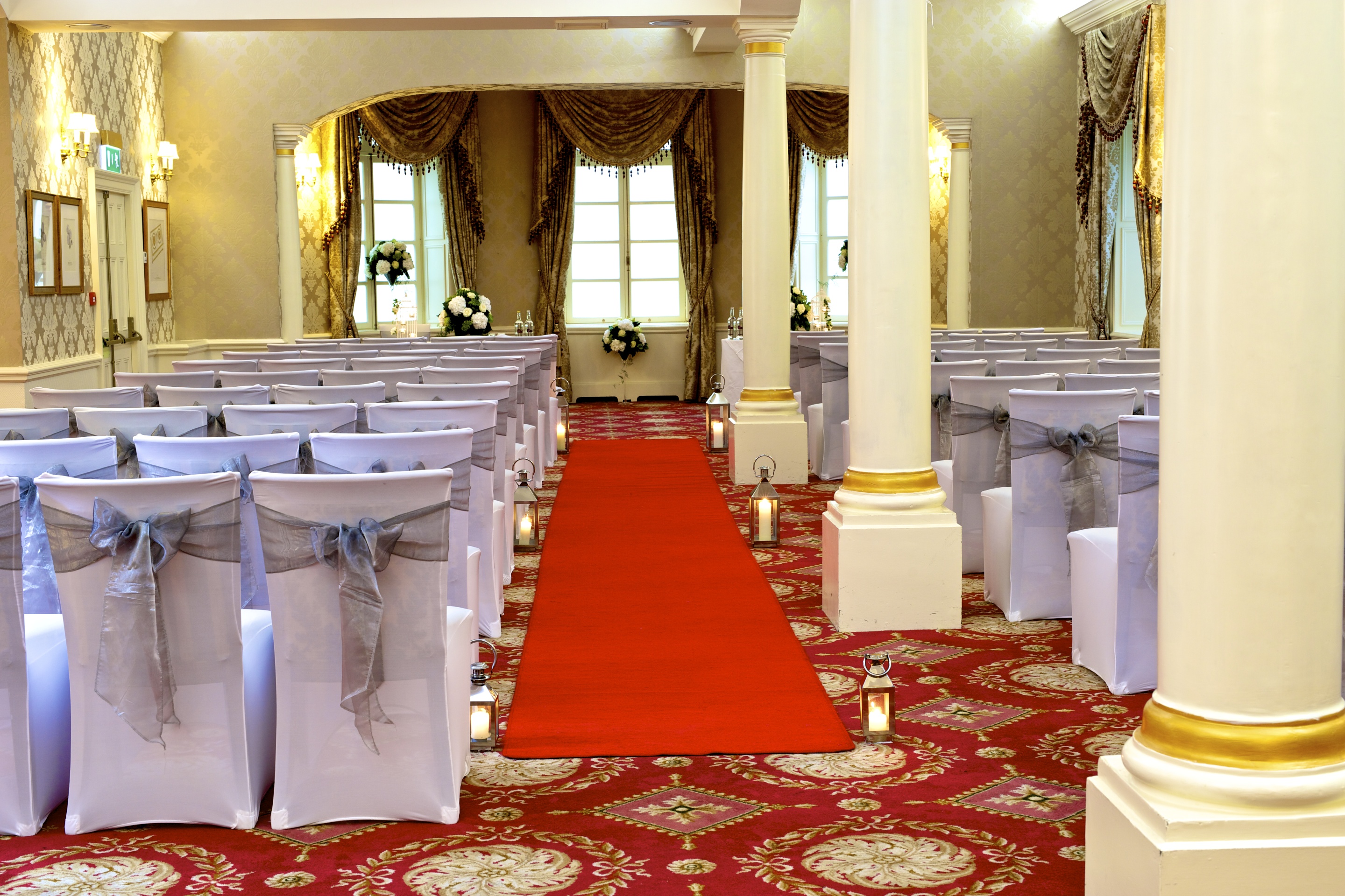 Faberge event space at Luton Hoo Hotel, elegant chairs and red carpet for weddings.