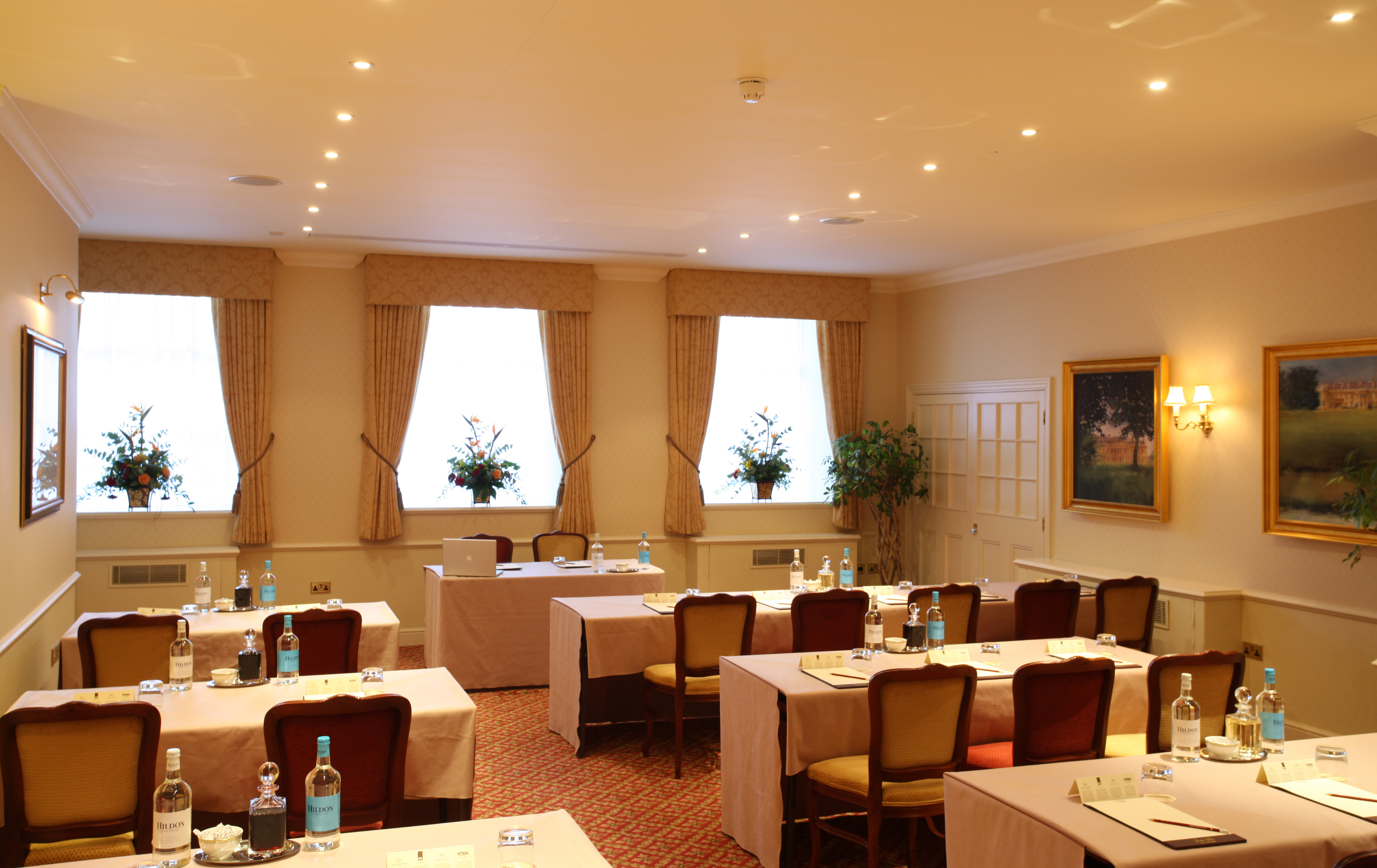Philip Tilden in elegant meeting room at Luton Hoo Hotel for professional events.