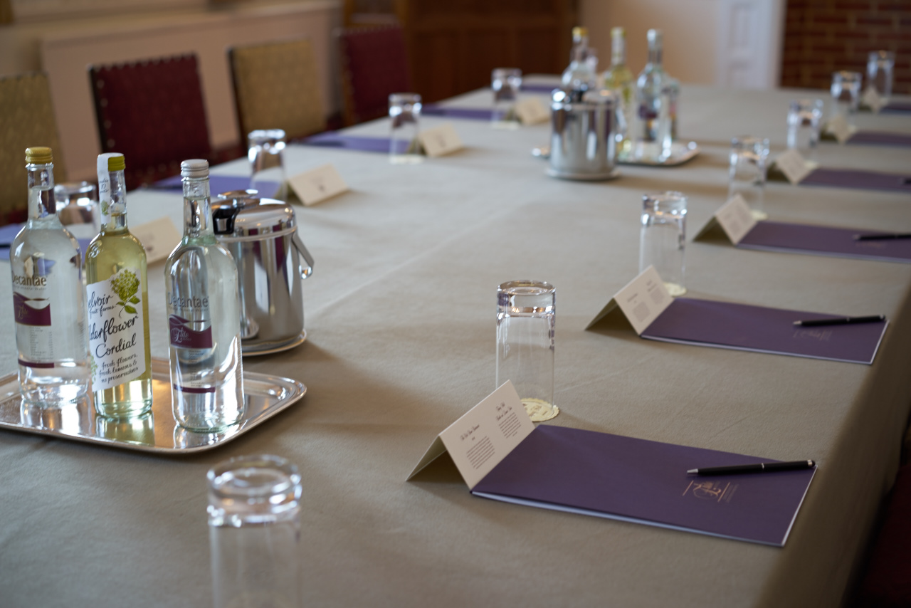 Newnham Suite meeting setup at Tylney Hall, featuring elegant table arrangement and materials.