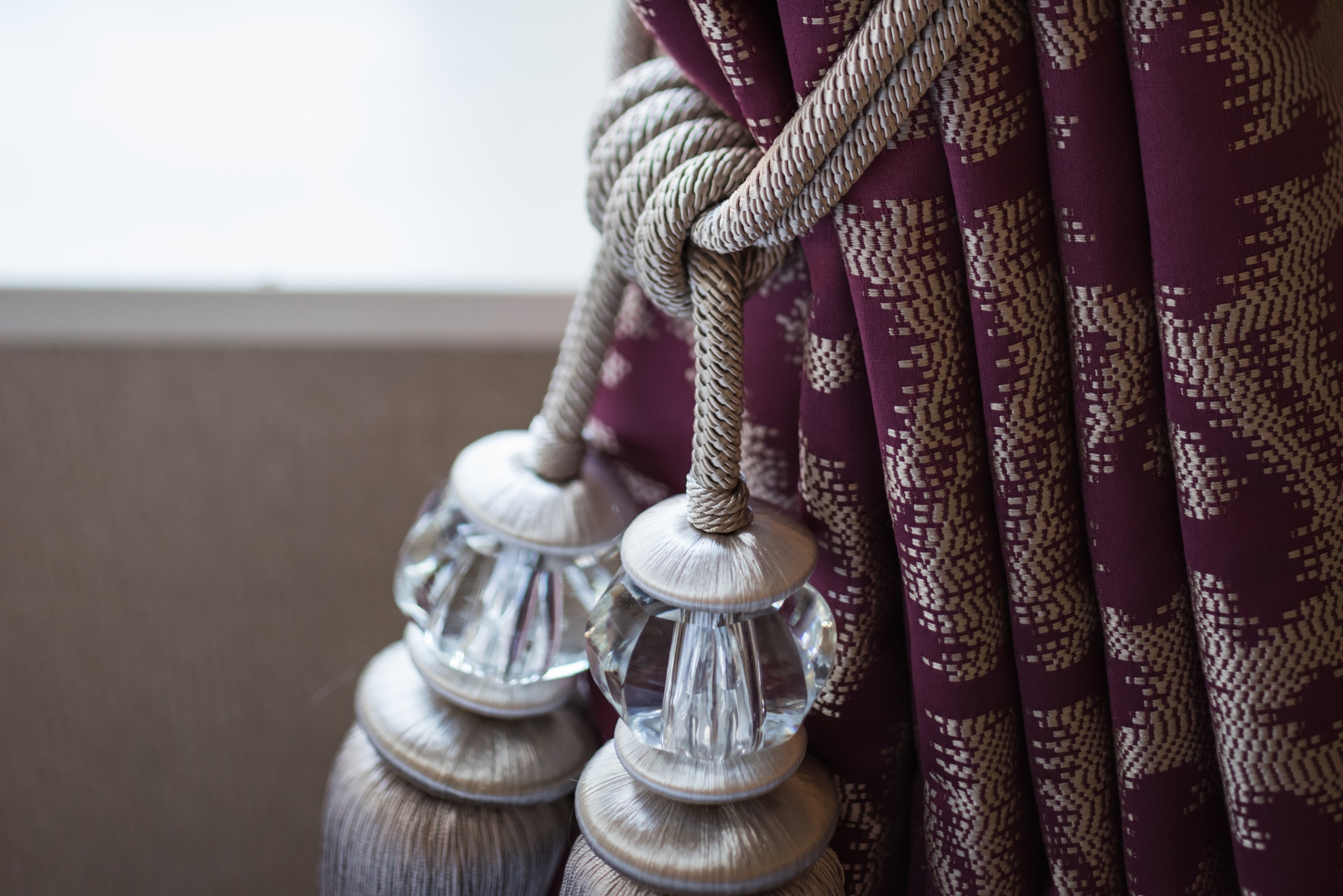 Elegant curtain tieback with crystal accents at Tylney Hall event space.