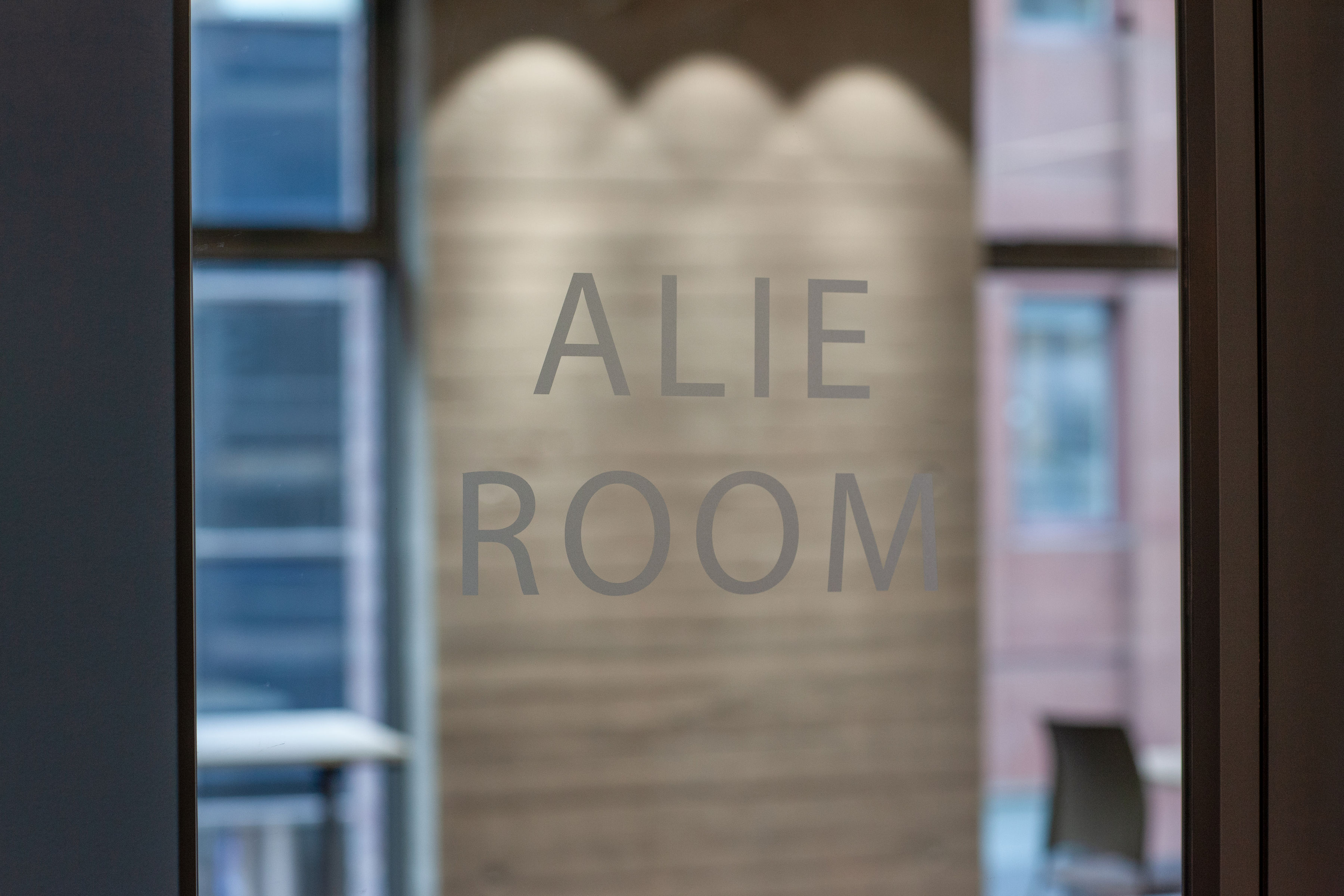 Modern Alie Room entrance with frosted glass door, perfect for corporate meetings.