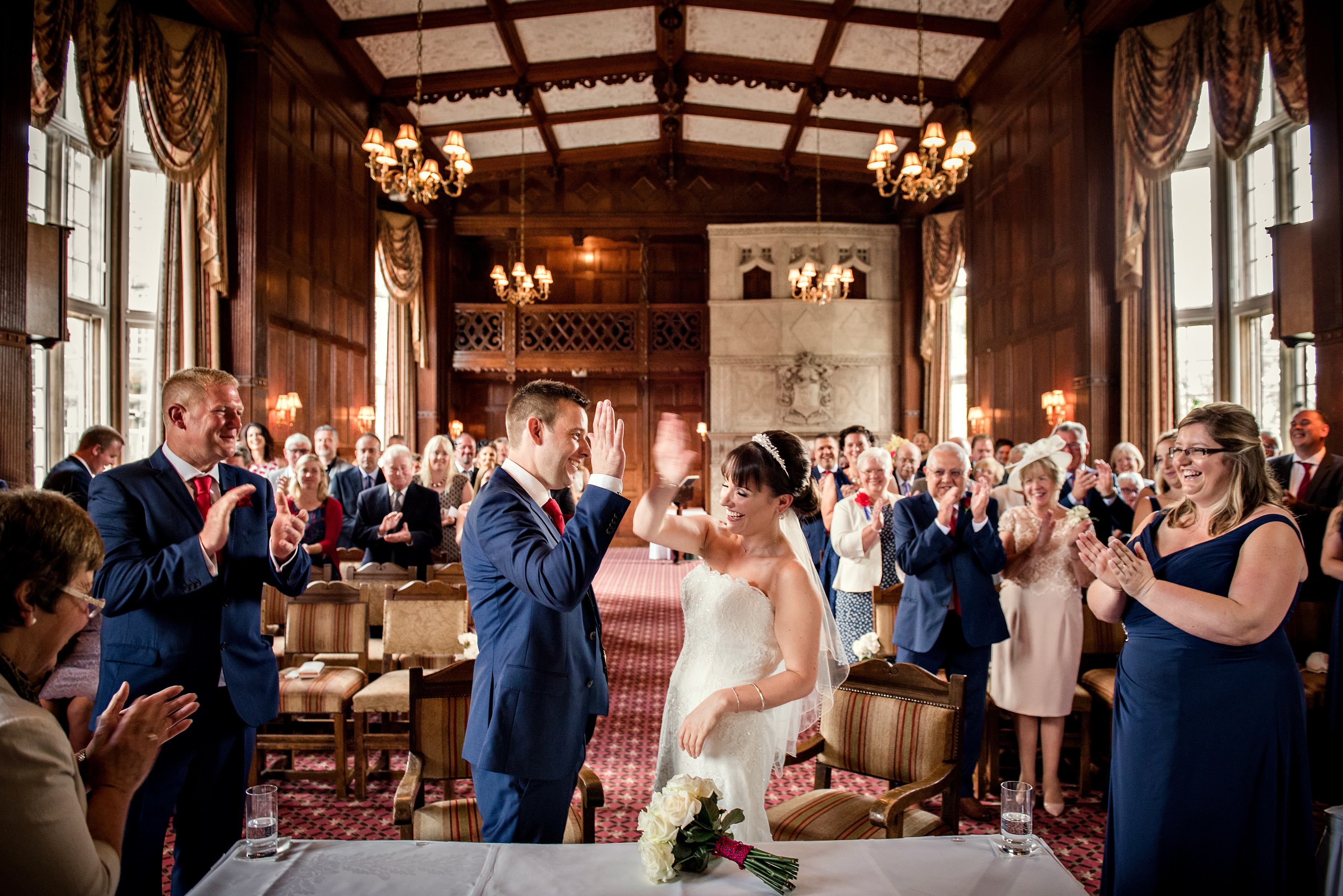 Elegant Tylney Suite wedding ceremony with warm lighting and rich wood paneling.
