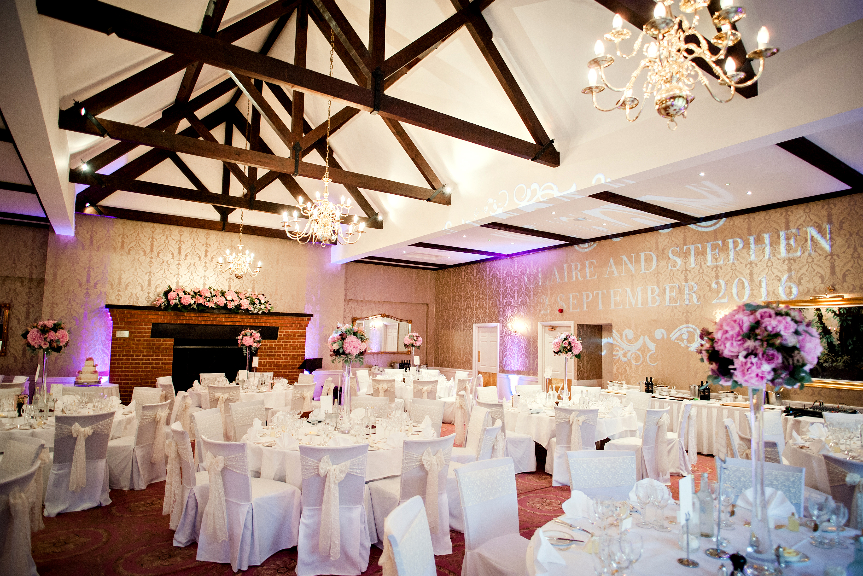 Chestnut Suite at Tylney Hall: elegant wedding banquet hall with floral decor and soft lighting.