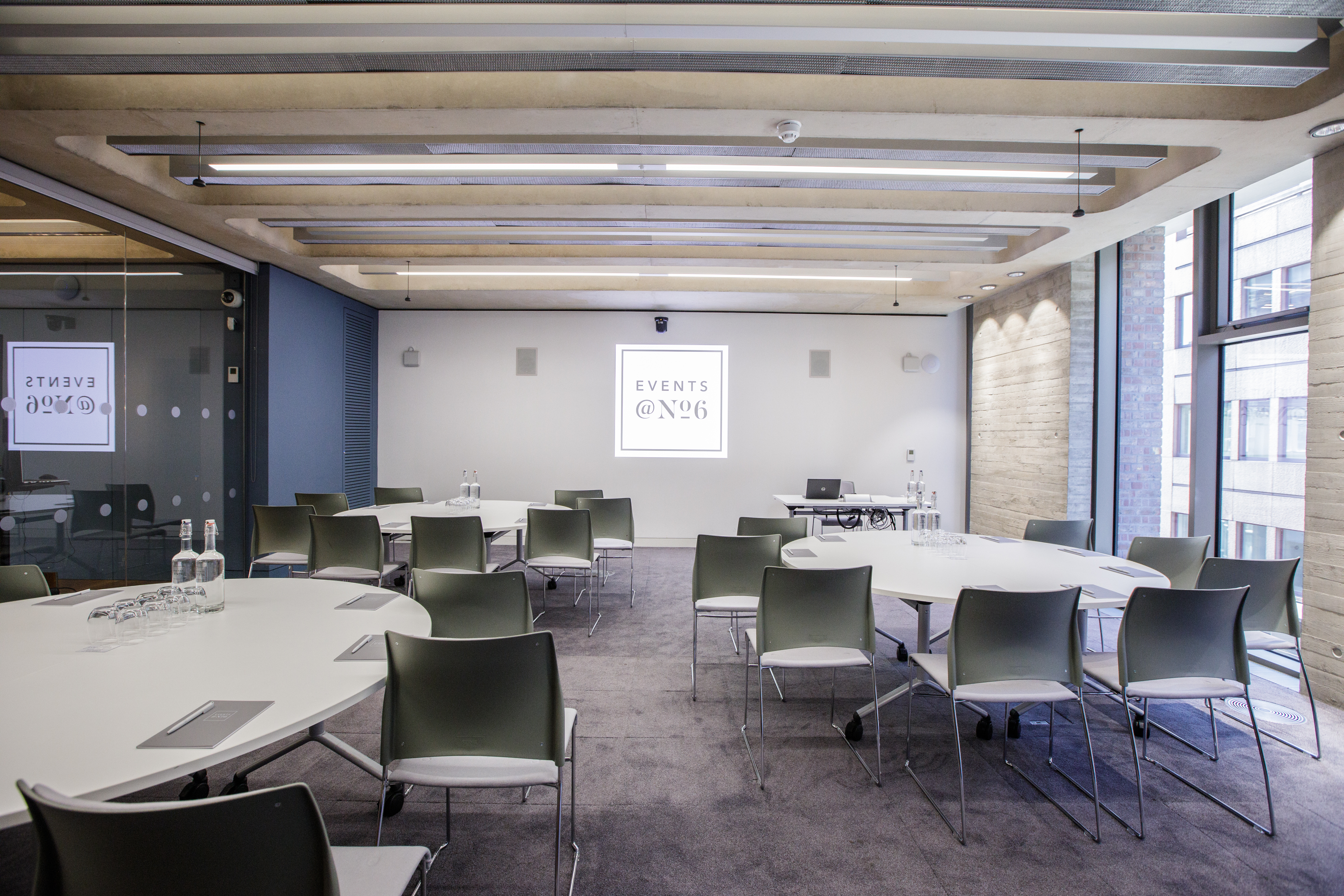 Modern Grosvenor Room with round tables for meetings and natural light at Events @ No 6.