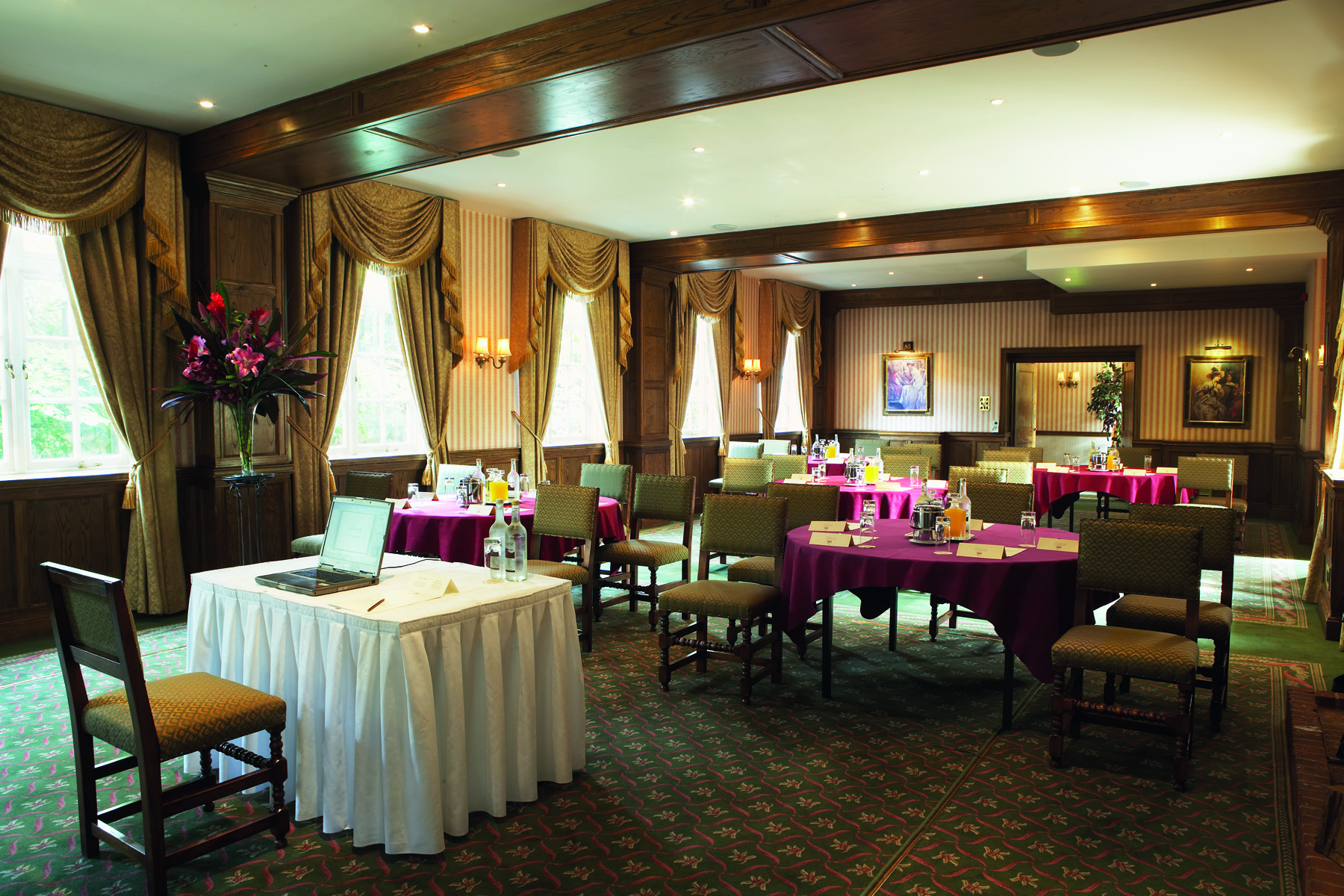 Sir Lionel Philips in elegant meeting room at Tylney Hall for corporate events.