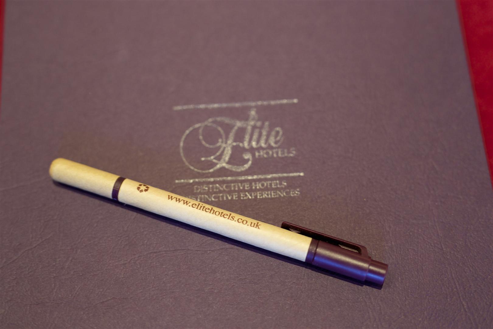Branded pen on leather notebook at Viscount Castlemaine, ideal for professional events.