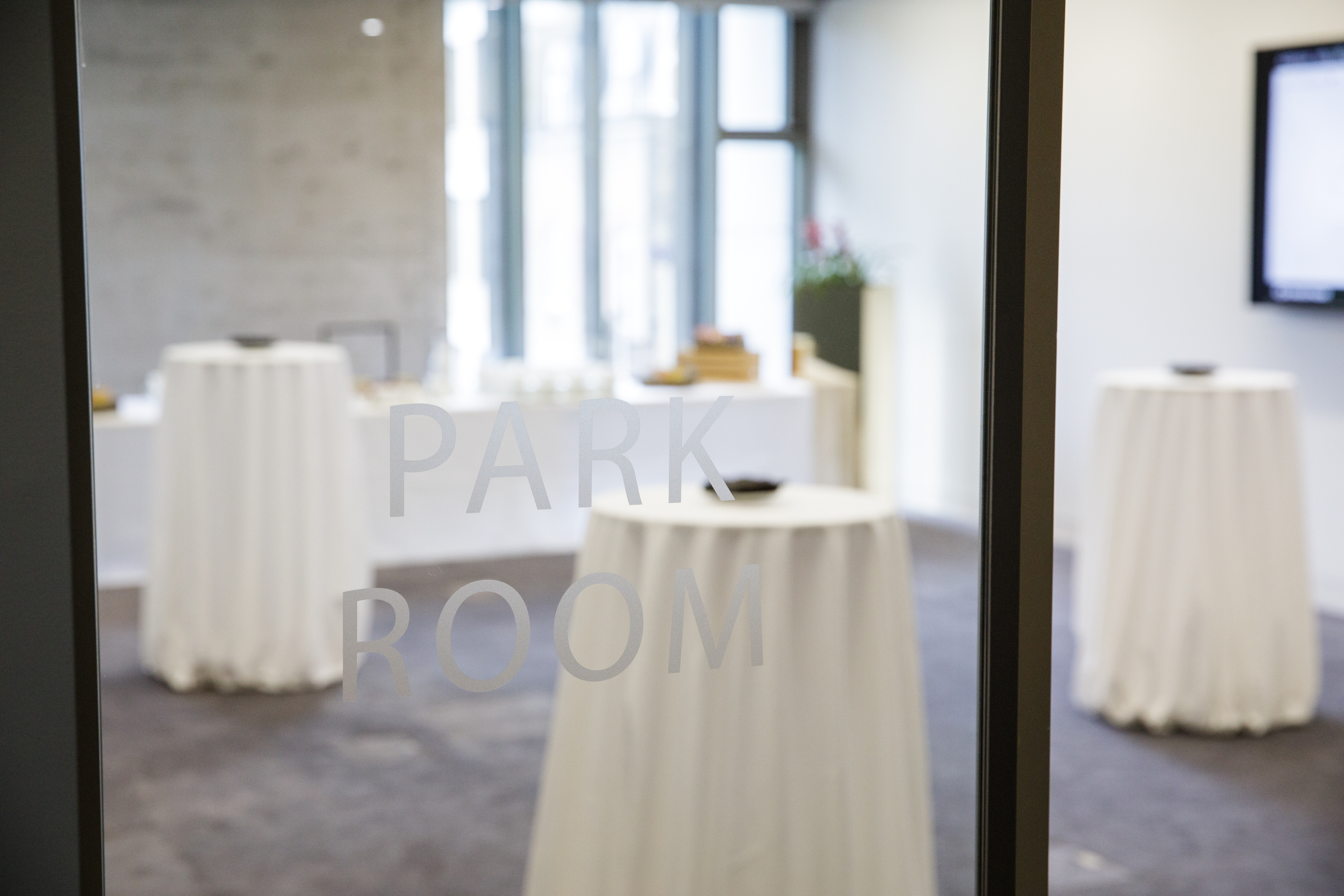 Elegant Park Room event space with high-top tables, ideal for corporate gatherings.