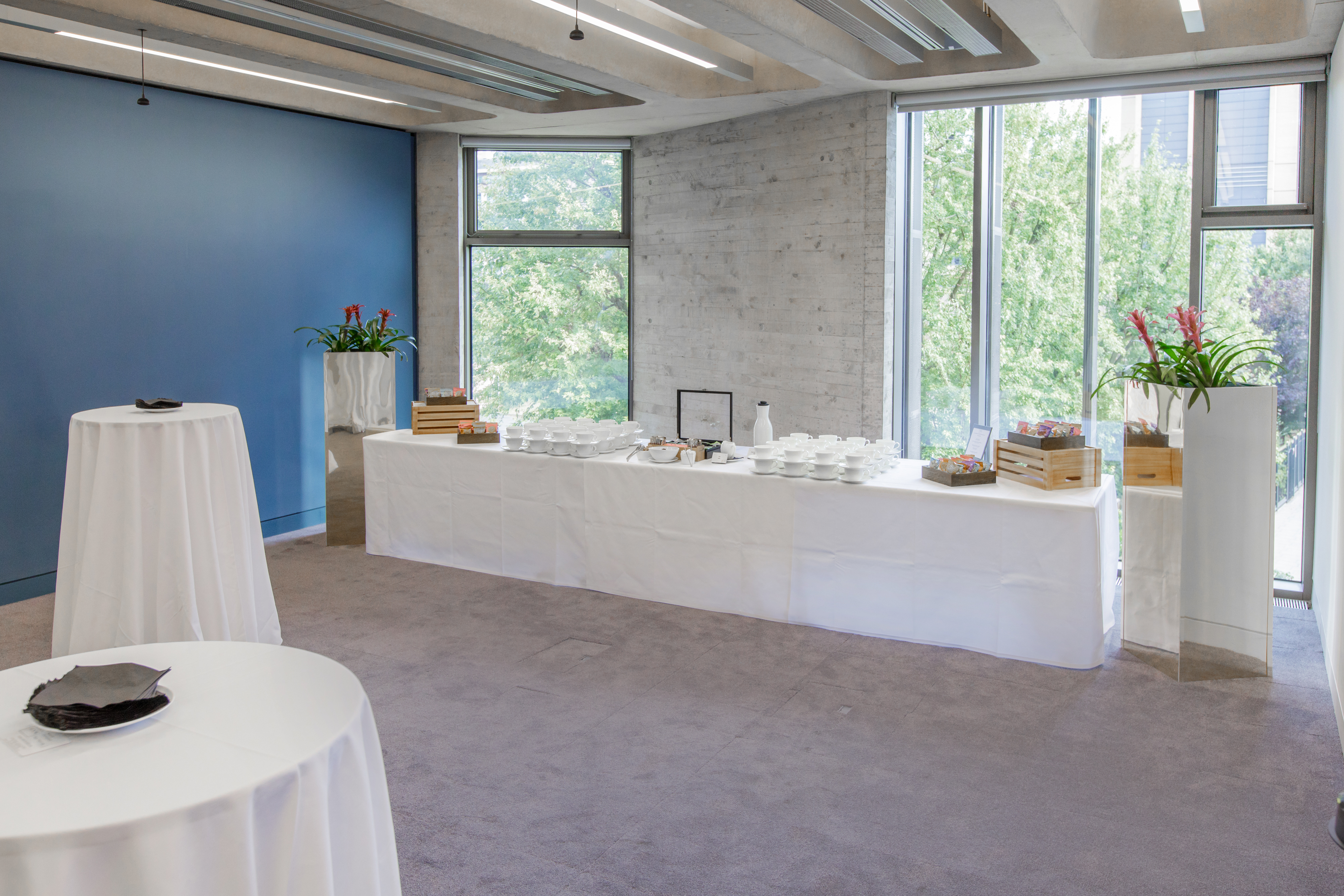 Elegant Park Room event space with high-top tables and natural light for corporate gatherings.