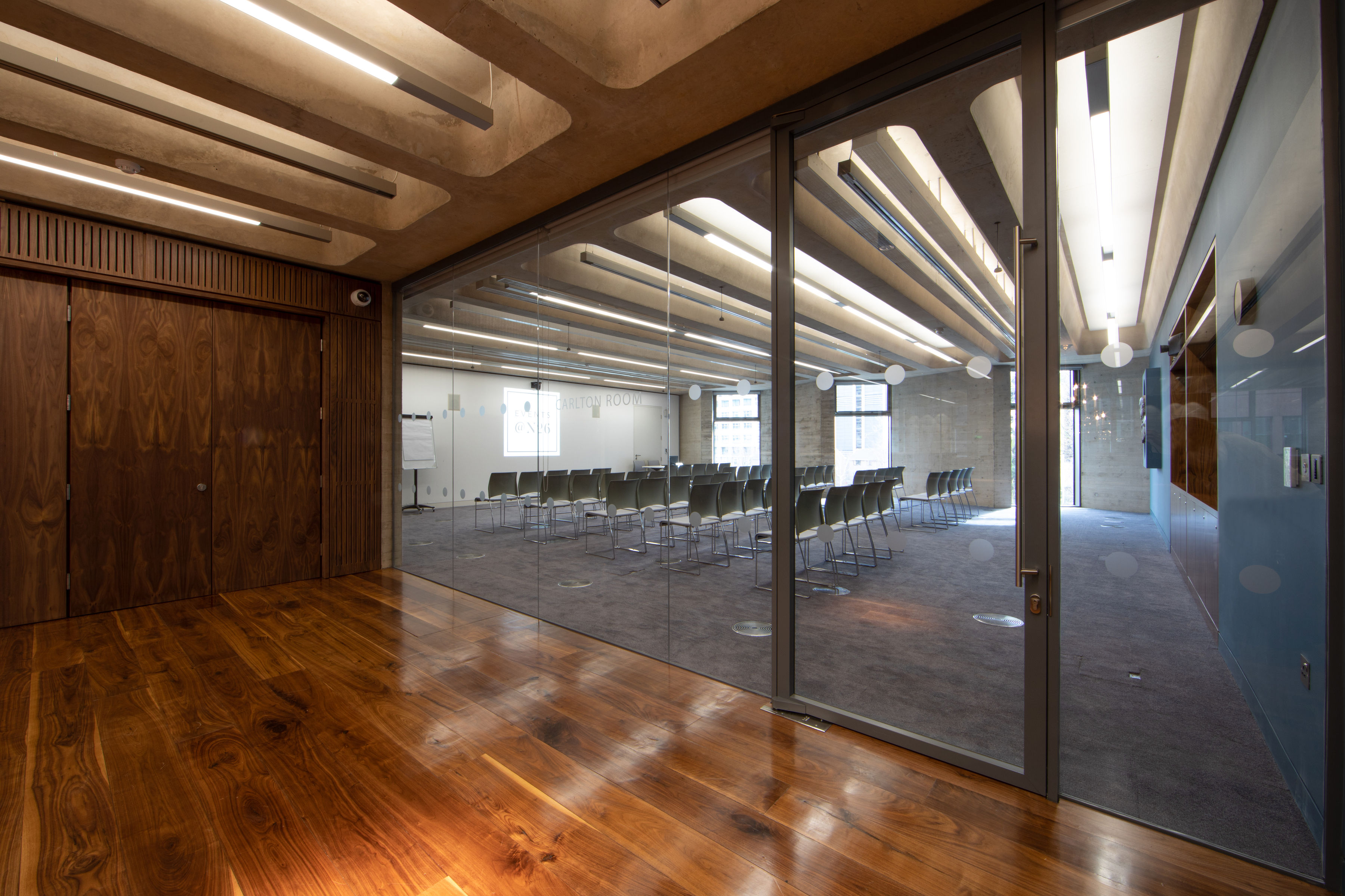 Modern Carlton Room with large windows, perfect for workshops and presentations.