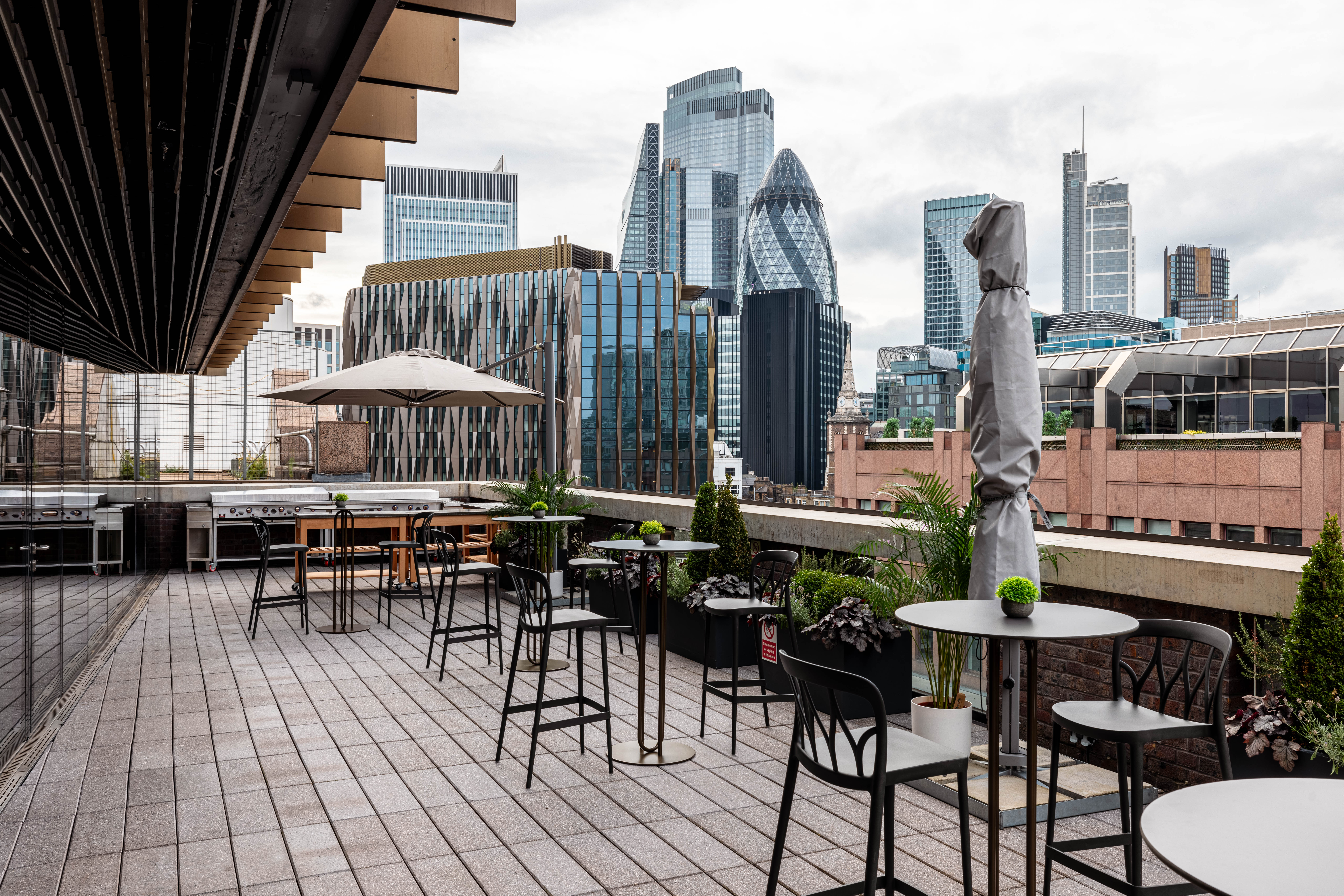 Stylish rooftop terrace with city skyline, ideal for networking events and cocktail receptions.