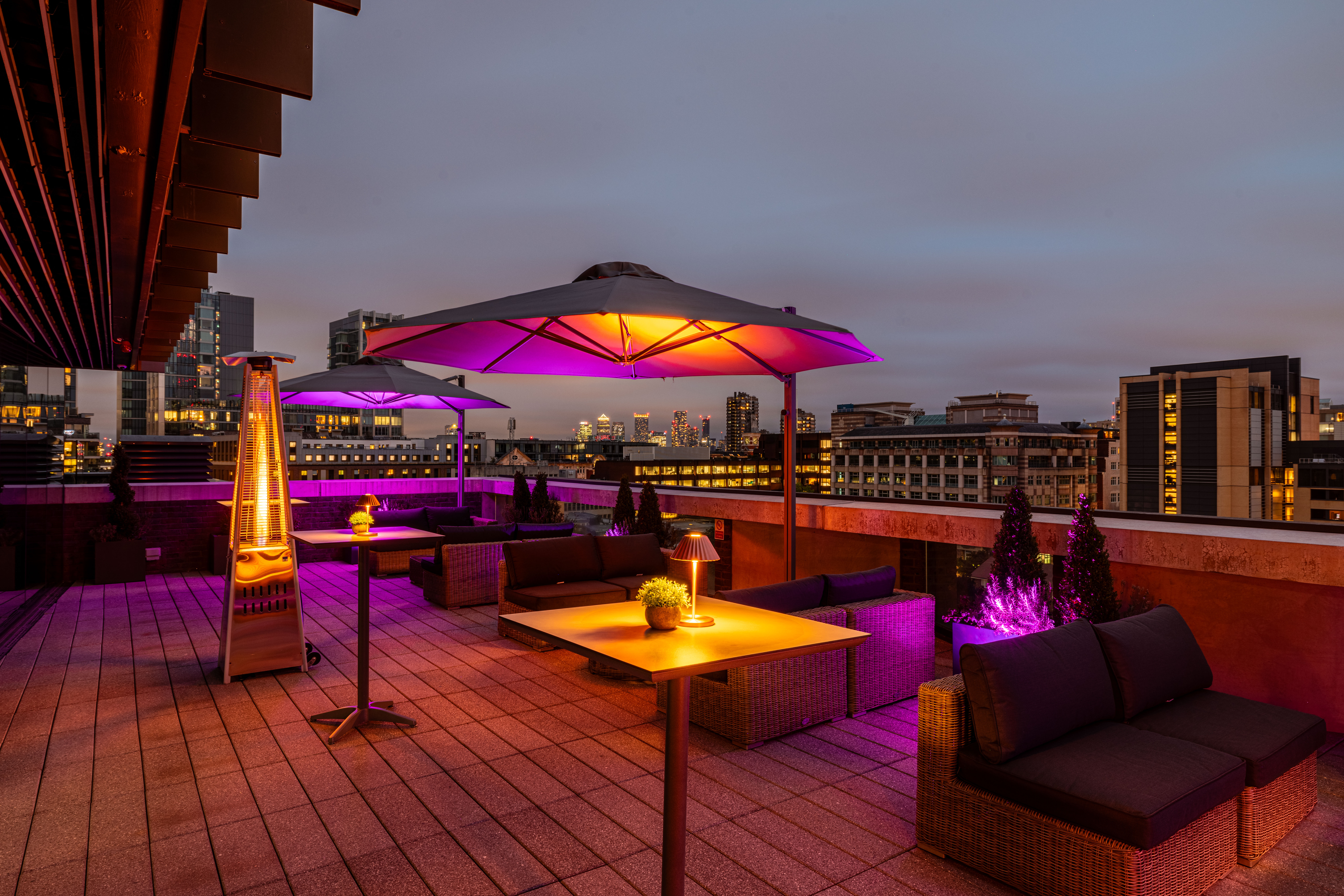 Stylish rooftop venue with city skyline, perfect for upscale events and gatherings.