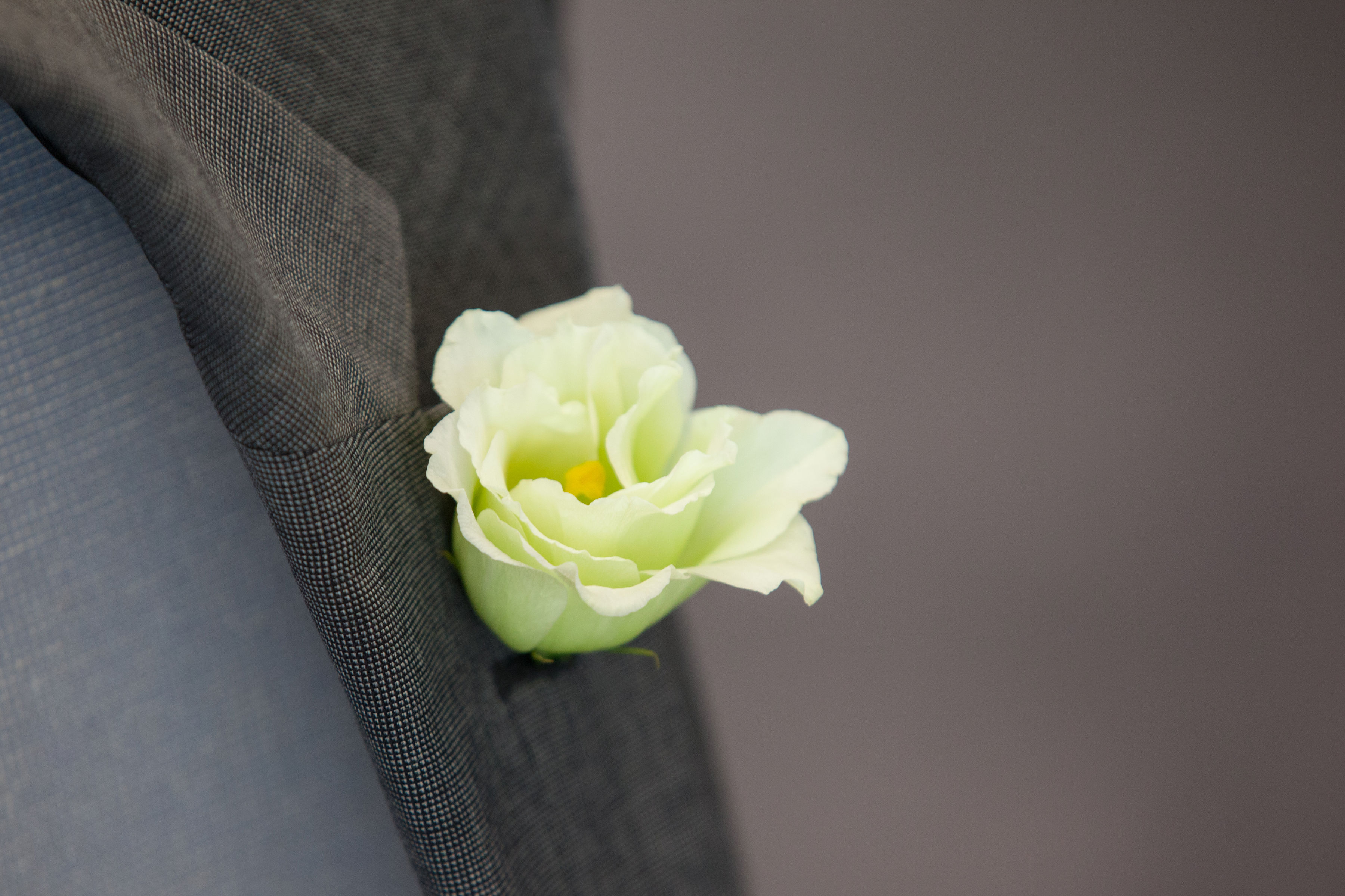 Elegant suit jacket with floral boutonnière for formal event planning at Terrace Room.