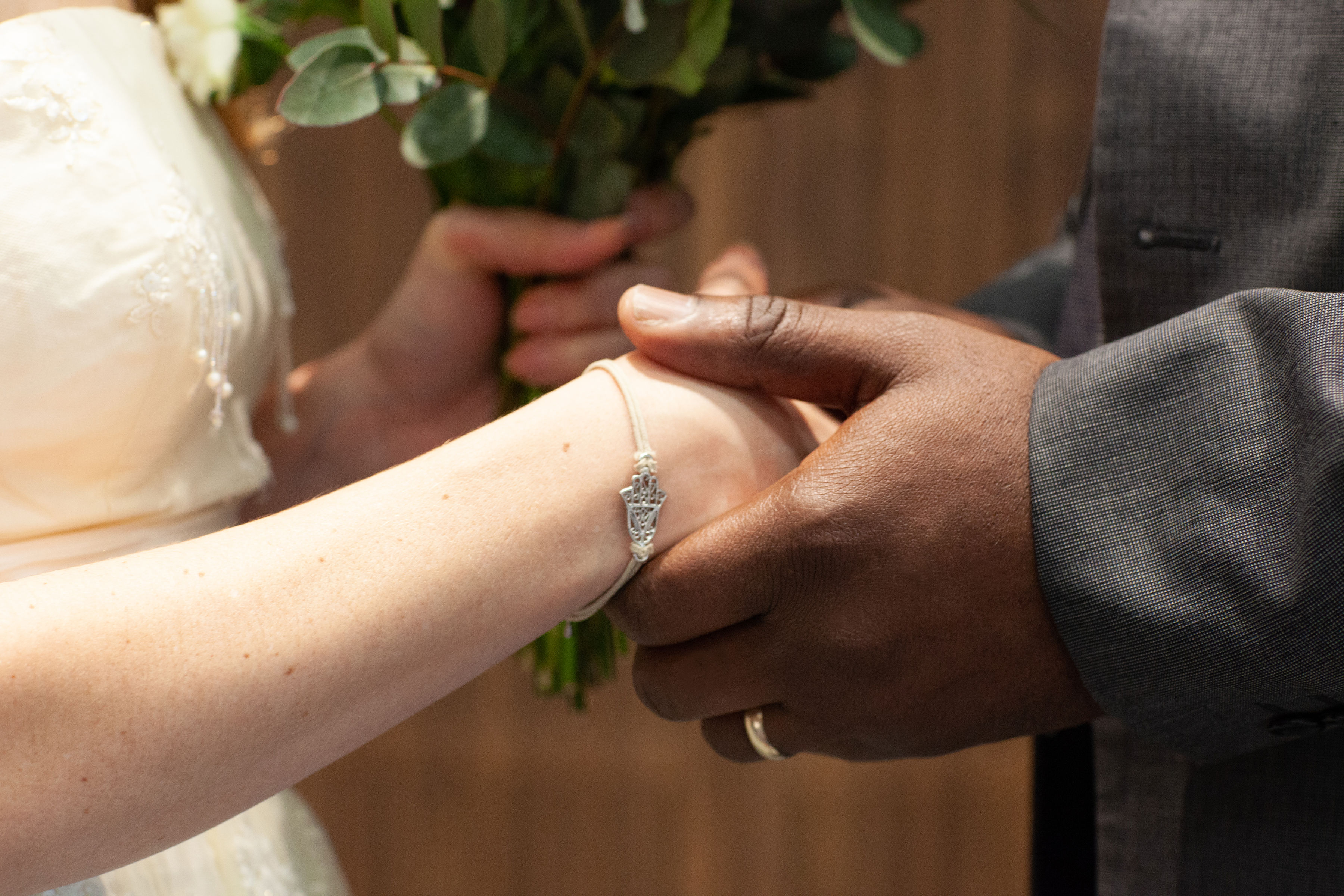 Clasped hands symbolize unity in the Terrace Room for weddings and intimate gatherings.