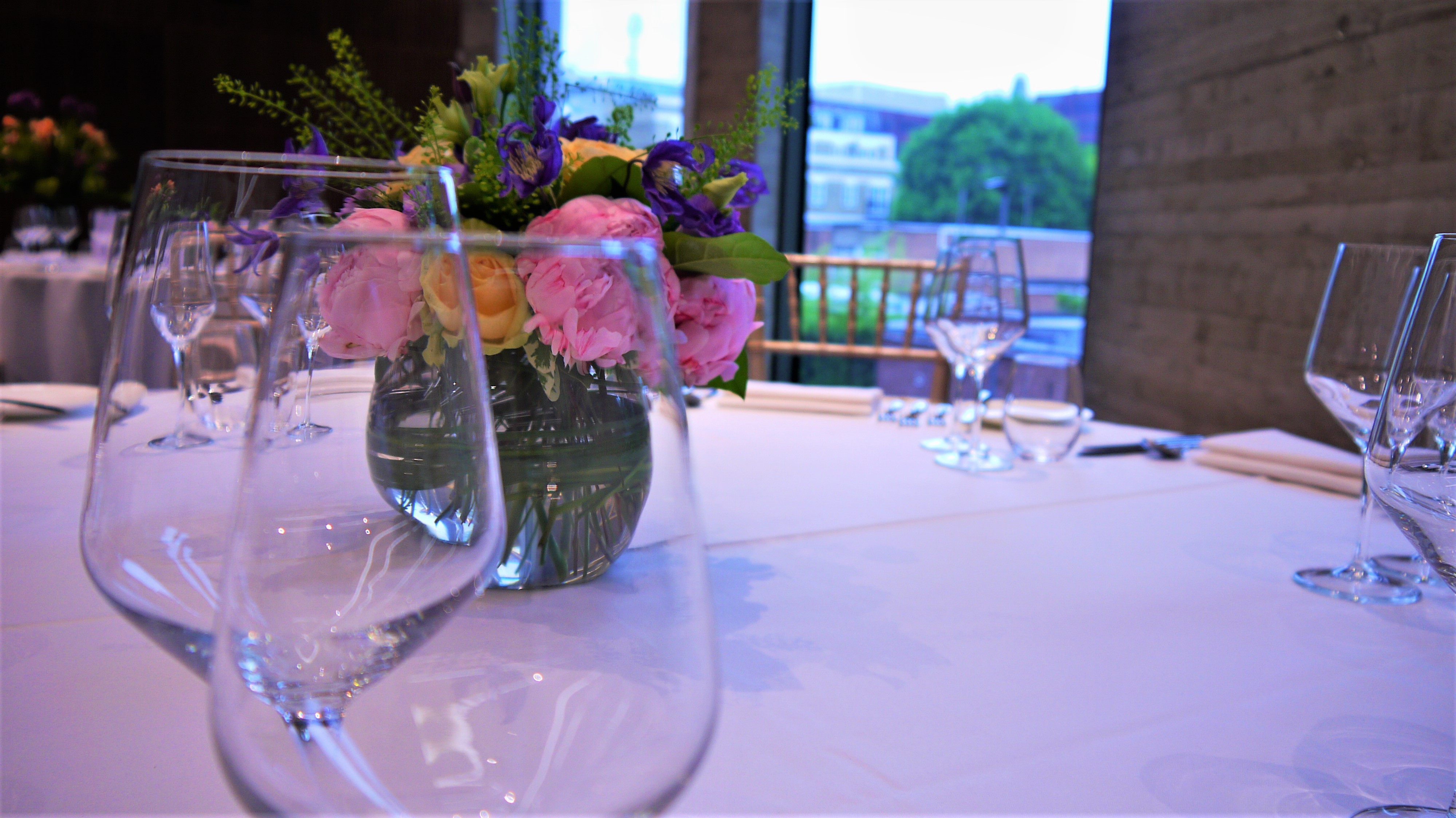 Elegant table setting with floral centerpiece in Terrace Room for events and celebrations.
