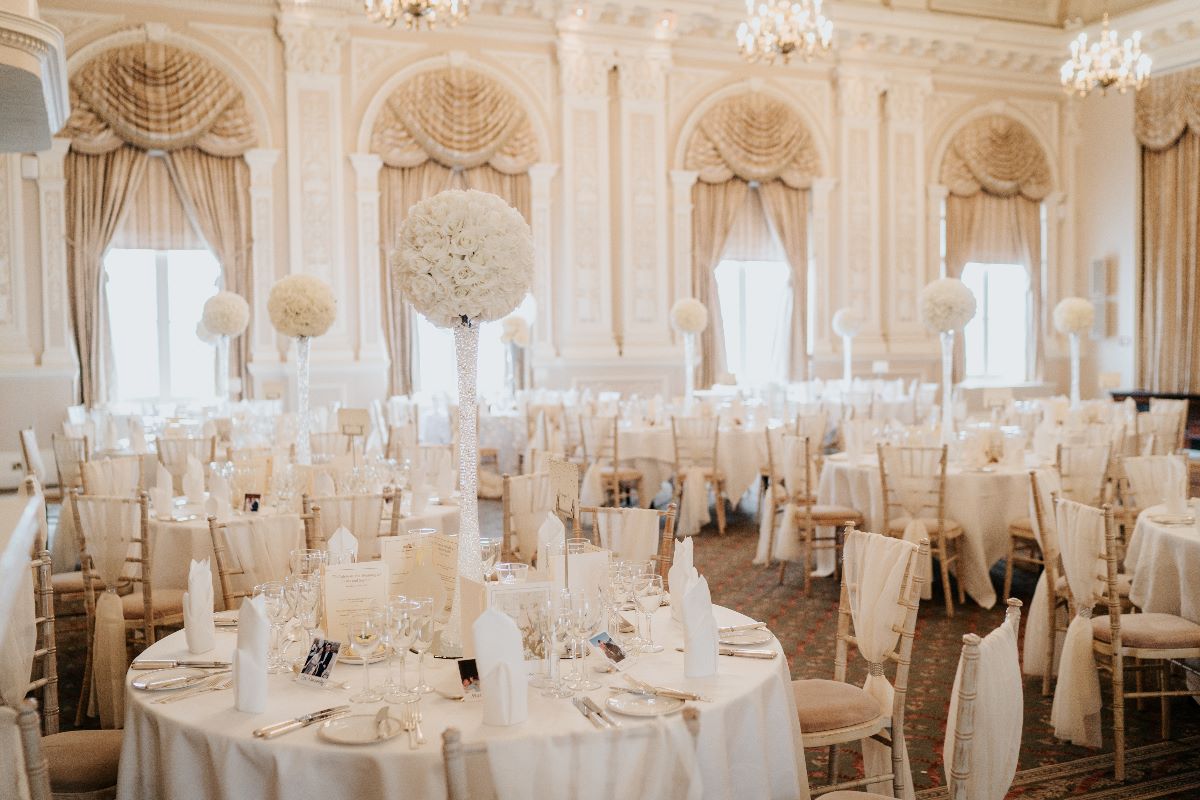 Elegant banquet hall with floral centerpieces, perfect for weddings and corporate events.