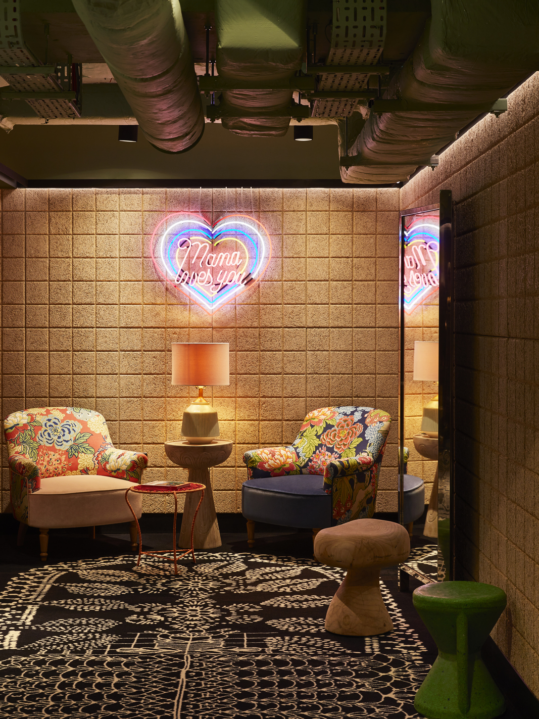 Cozy lounge at Mama Shelter London with vibrant floral chairs for networking events.