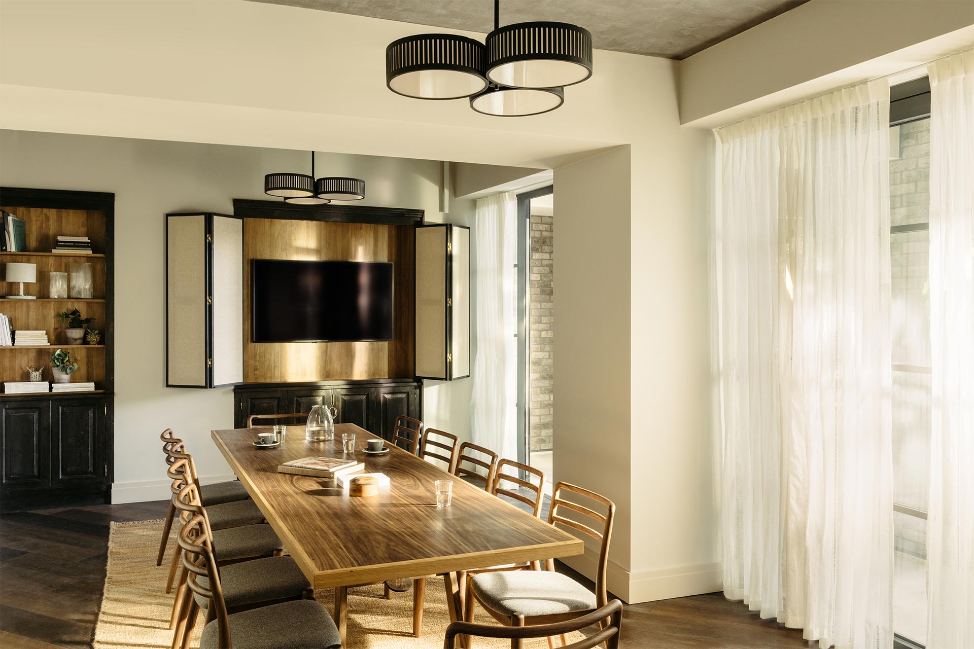 Modern meeting room at The Hoxton Southwark with large wooden table for events.