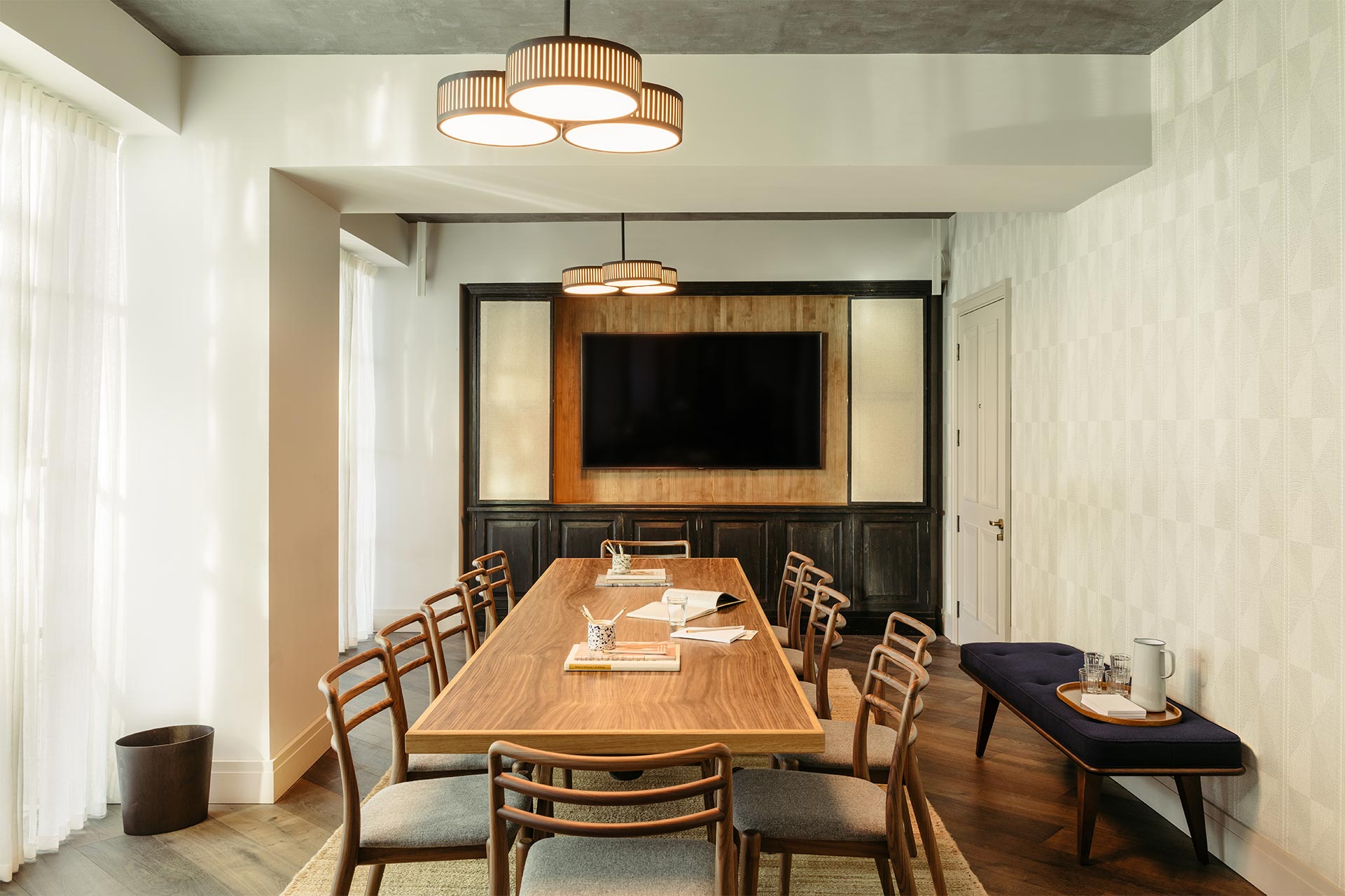 Modern meeting room at The Hoxton Southwark with wooden table, ideal for corporate events.