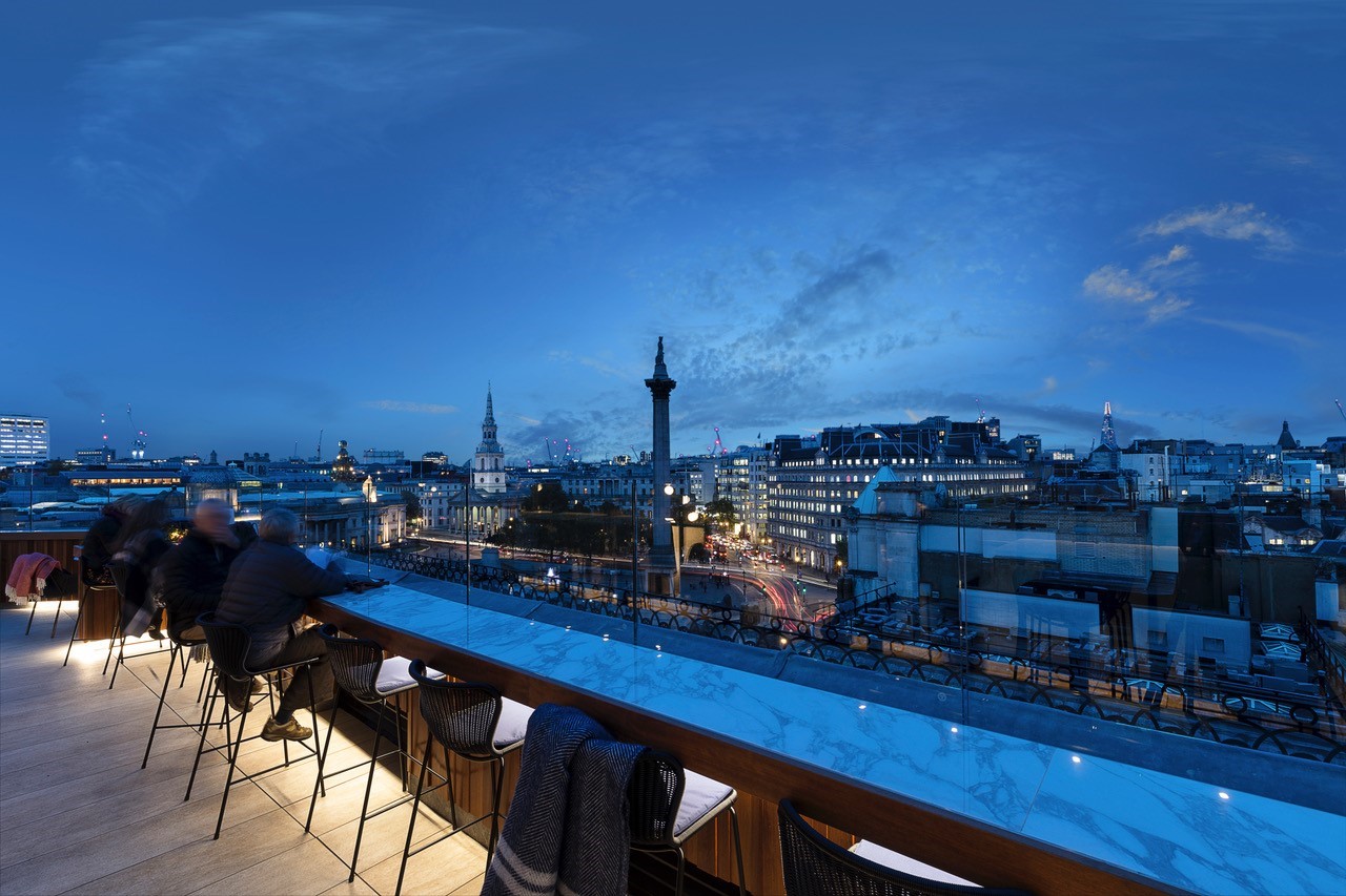 Rooftop venue at Trafalgar St James with city skyline, ideal for evening events.