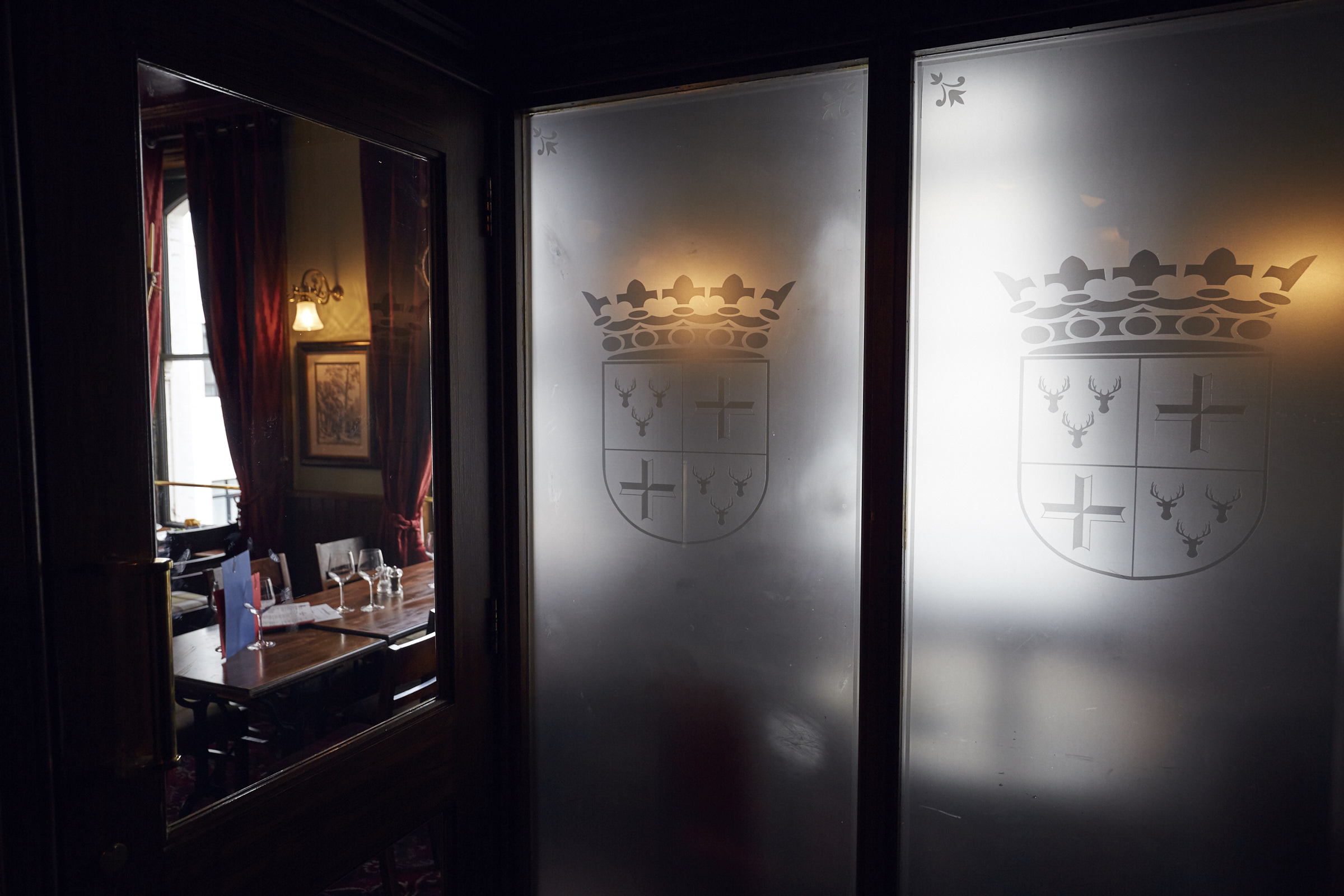Sophisticated meeting space with frosted glass doors for corporate events and gatherings.