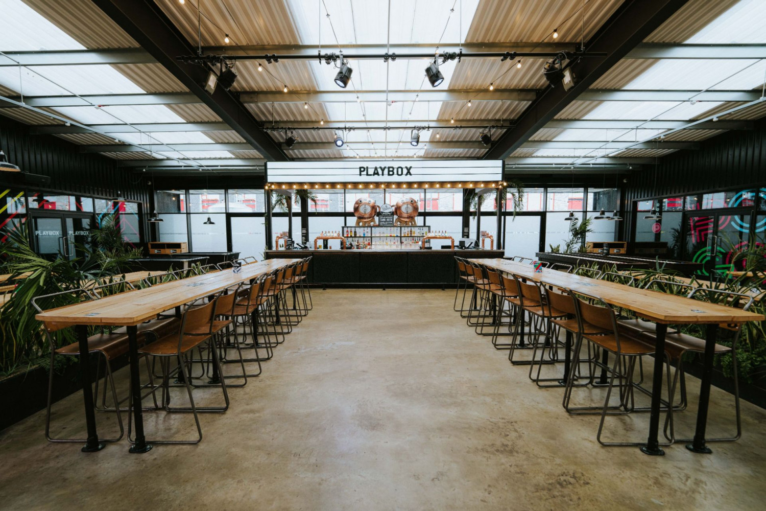 PlayBox Bar at Boxpark Wembley: versatile event space with glass ceiling for meetings and gatherings.