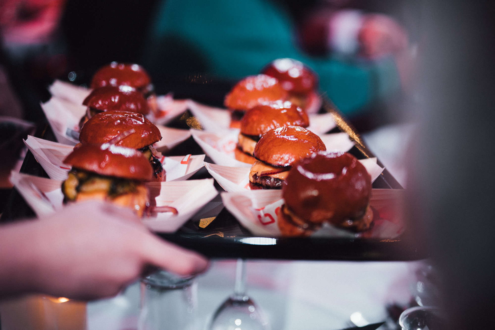 Gourmet sliders on a tray at PlayBox Bar, perfect for networking events and gatherings.