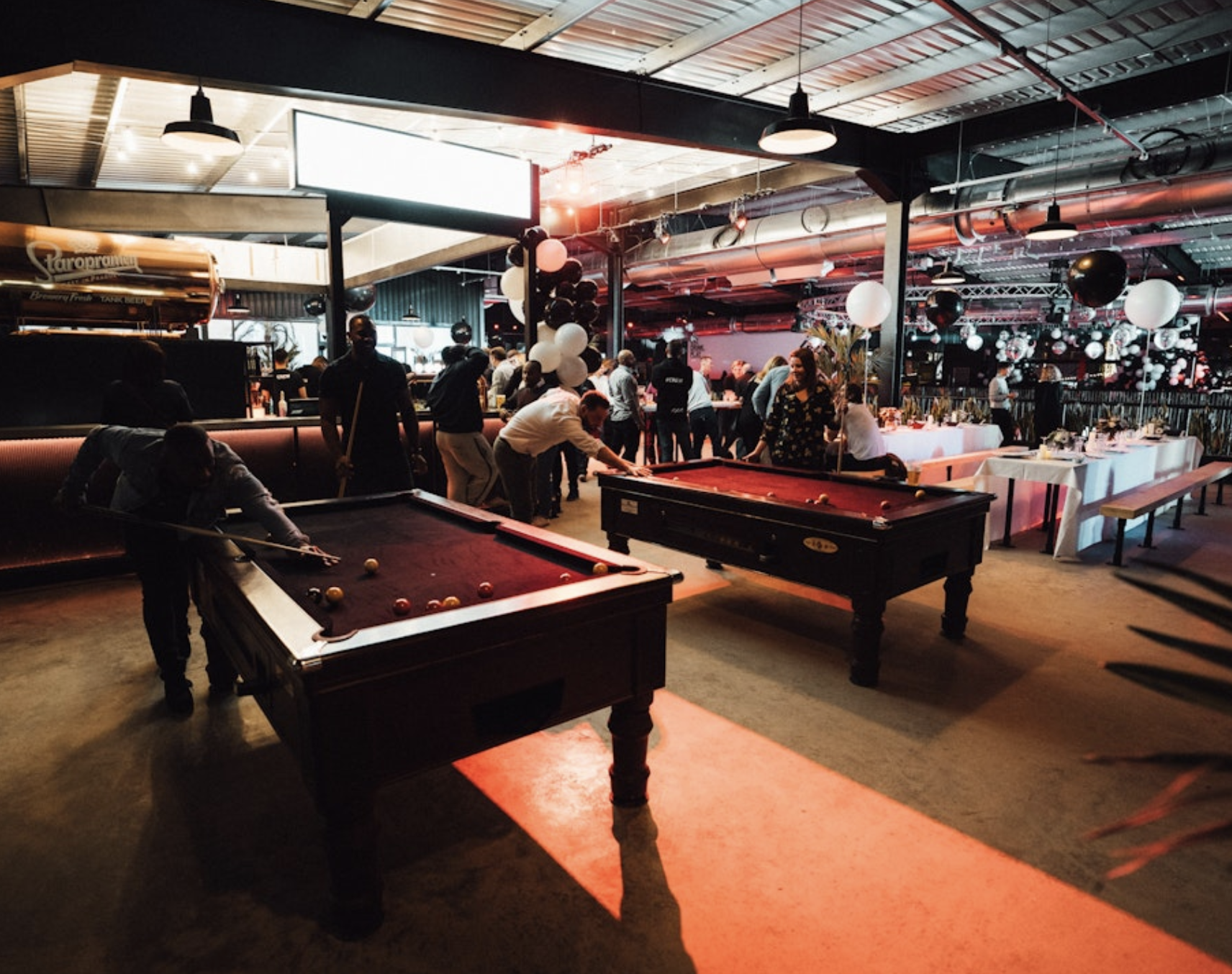 PlayBox Bar at Boxpark Wembley: vibrant event space with pool tables for networking and celebrations.