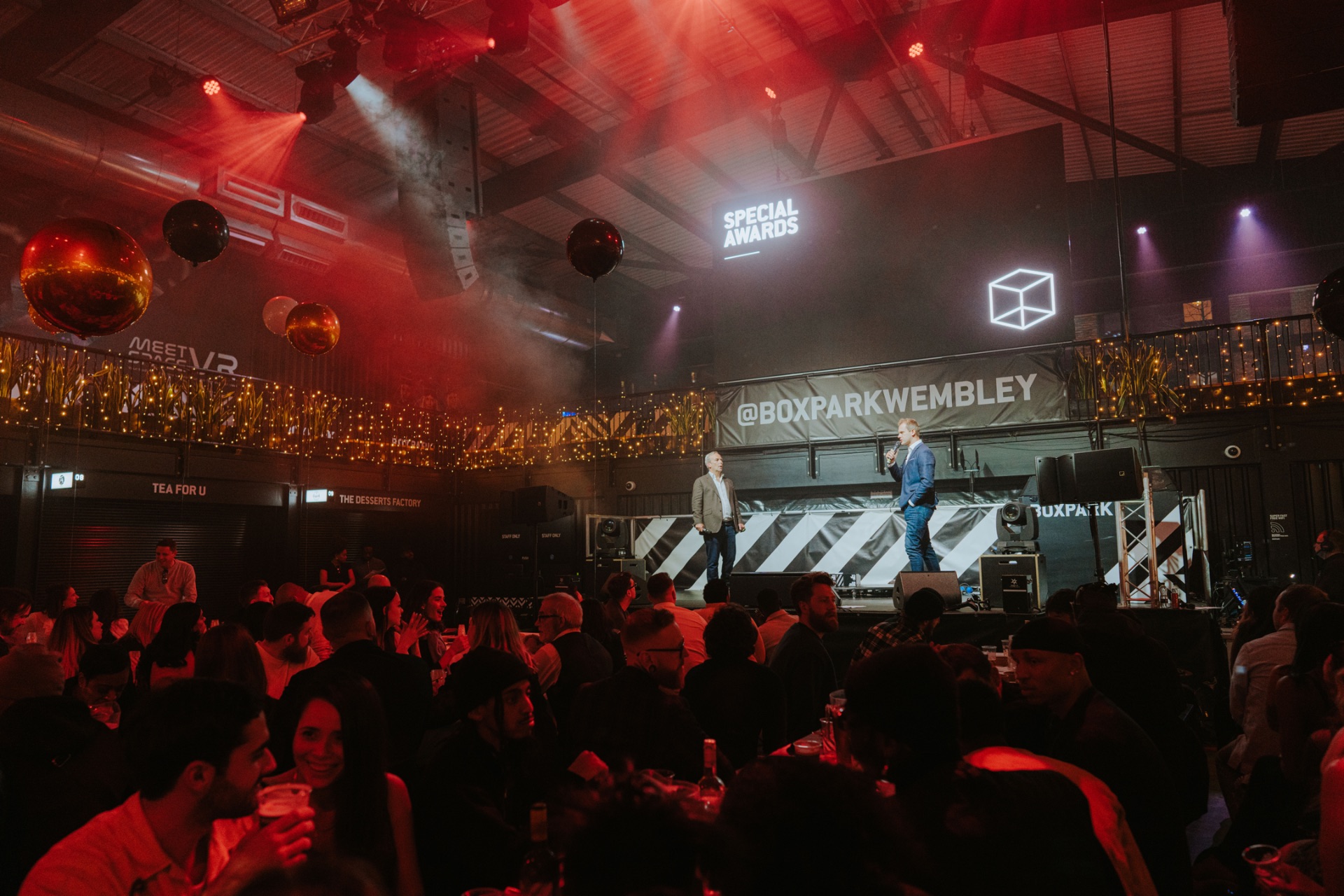 Vibrant Venue Takeover at Boxpark Wembley with engaging speakers and lively atmosphere.