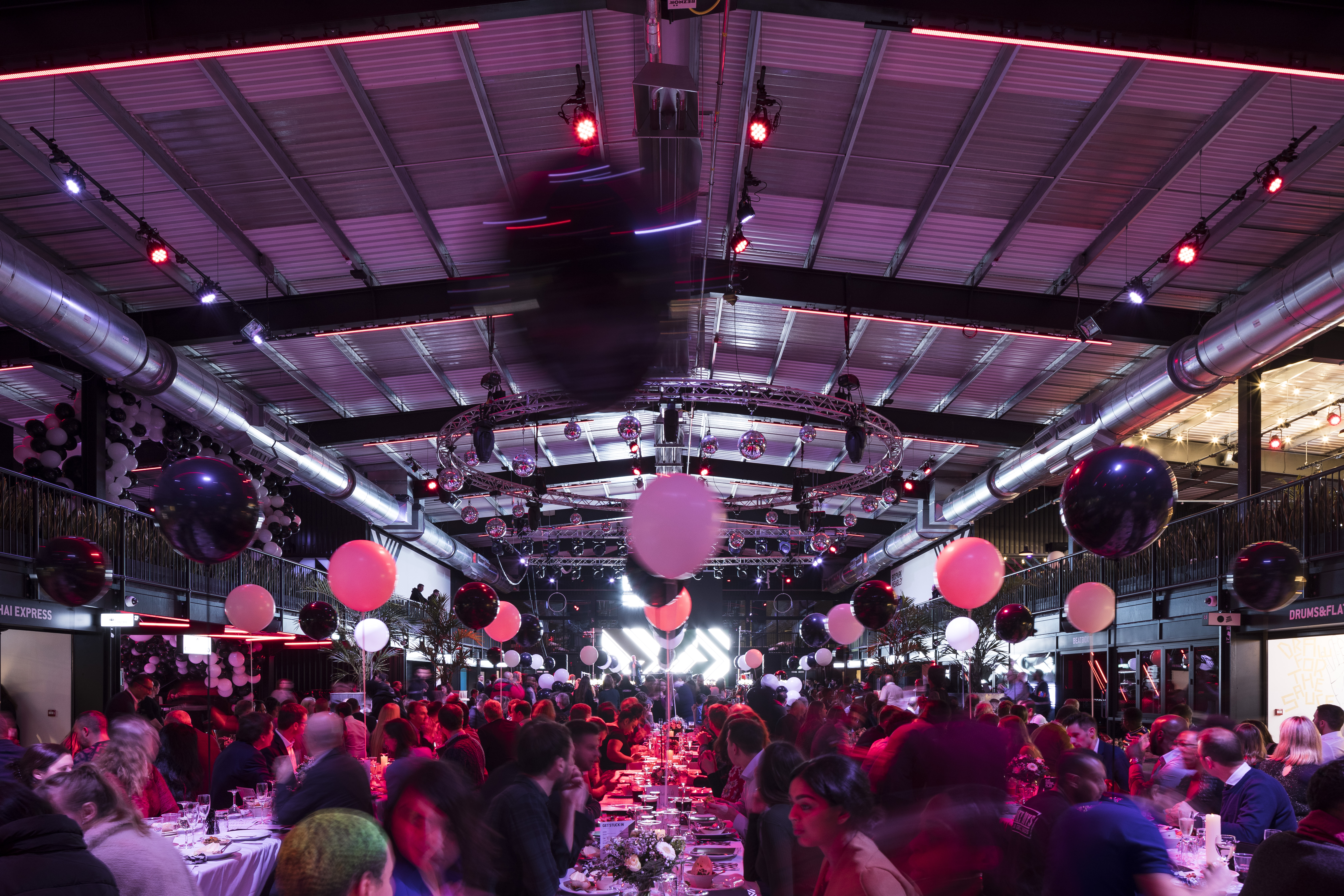 Vibrant gala event at Boxpark Wembley with colorful decor and lively atmosphere.