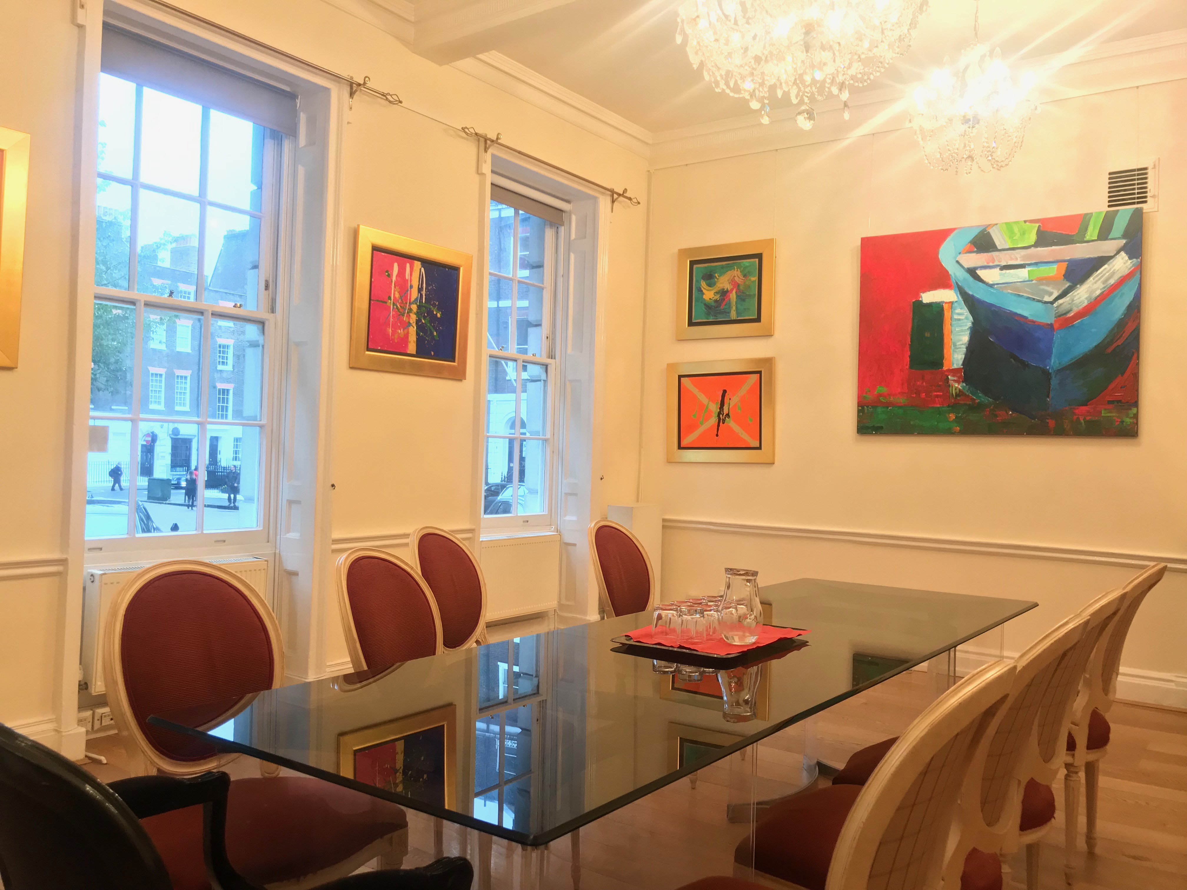 Elegant meeting room with glass table, ideal for events and collaboration.
