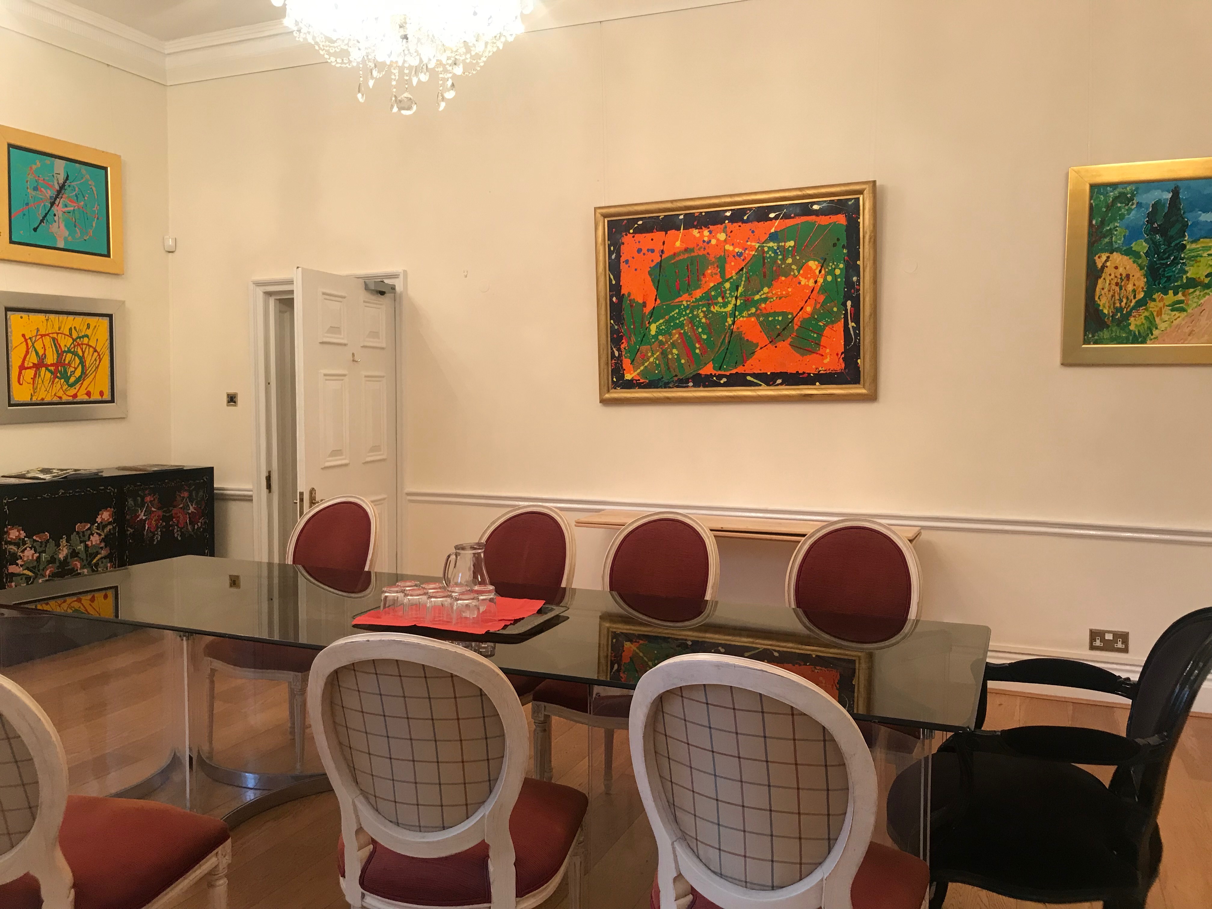 Stylish meeting room with glass table and artwork at Ratiu Family Foundation.